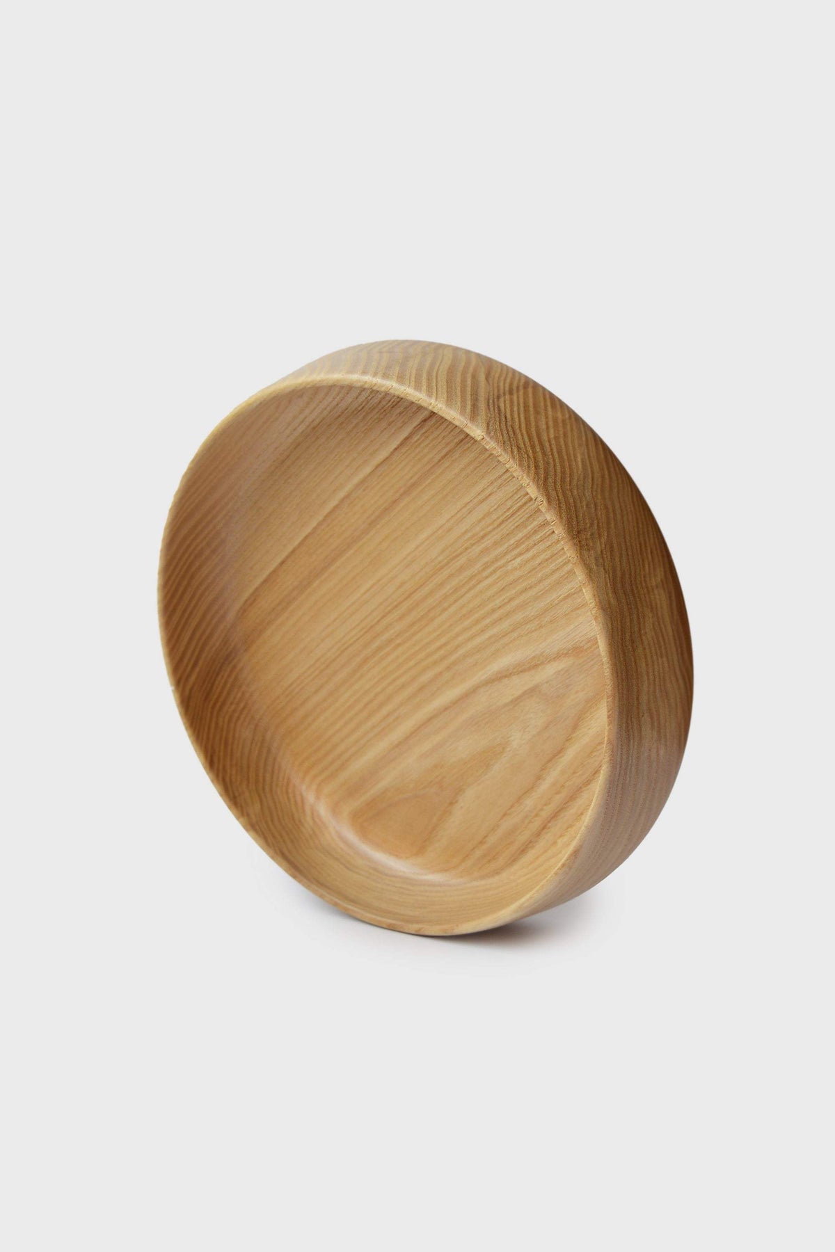 Hand Carved Wooden Plate in natural golden-brown wood with visible grain, a rounded shape and high carved sides