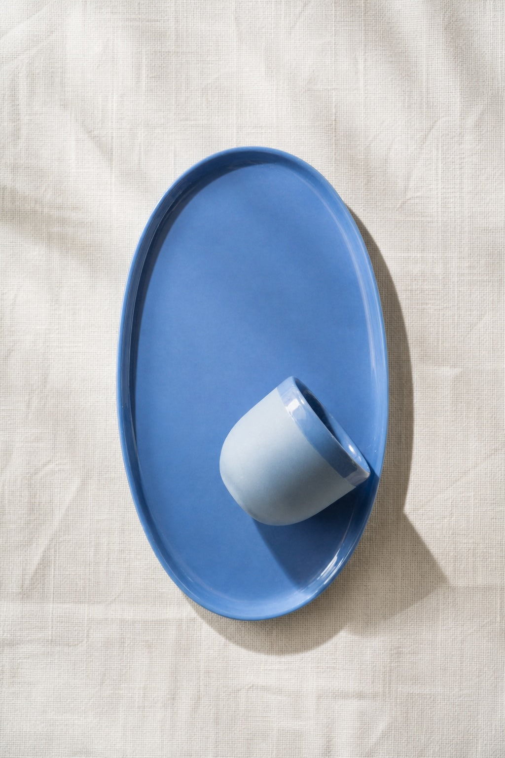 Oval Serving Platter in glossy blue porcelain, with a smooth glaze and gently raised rounded rim.