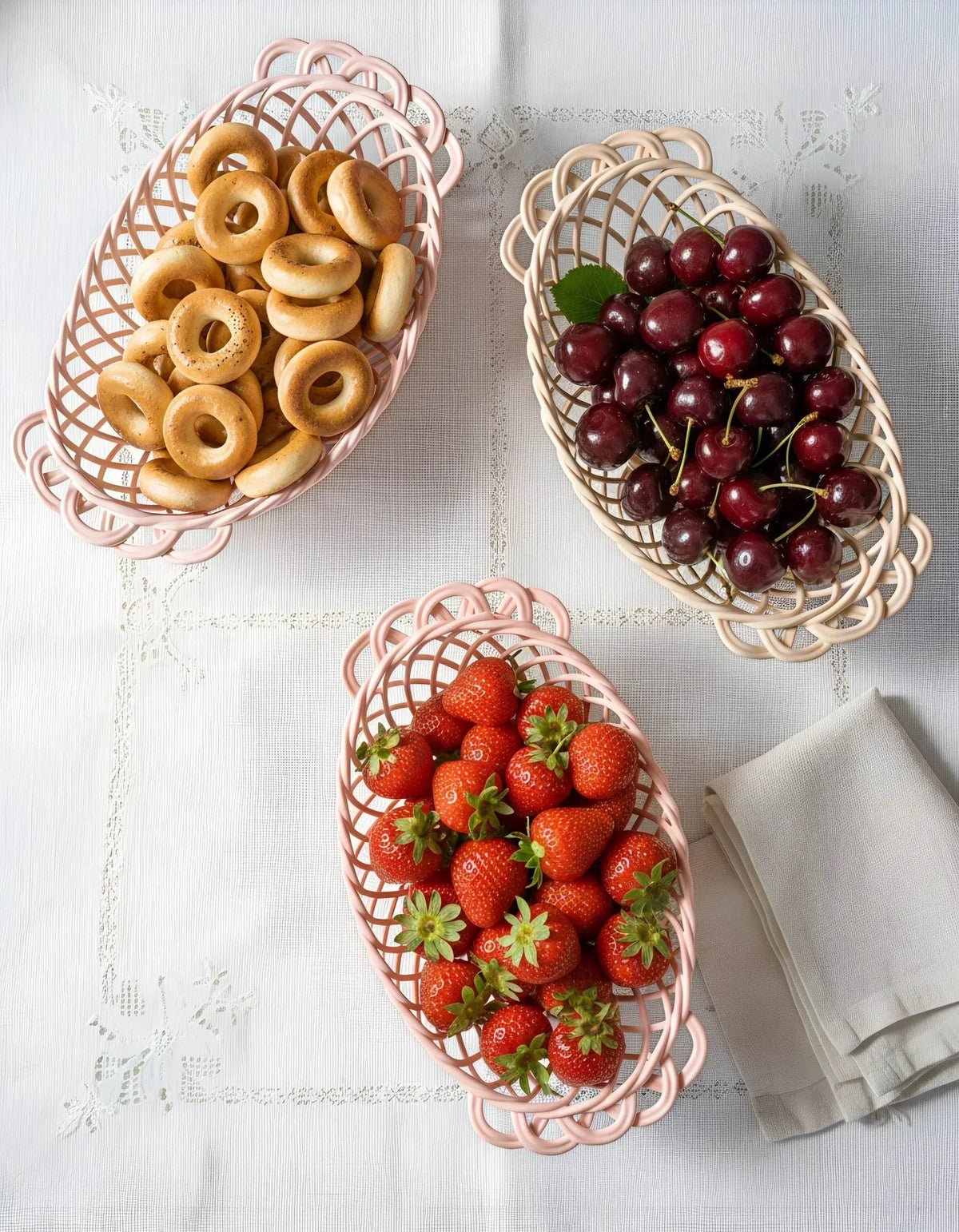 Ceramic Oval Basket, oval glazed porcelain with an open hand-woven lattice, shown in pink and beige tones.