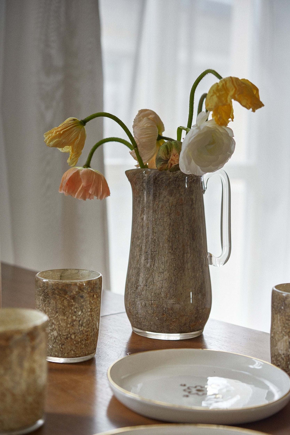 Elegant hand blown glass pitcher with marble pattern and sturdy handle for water and drinks