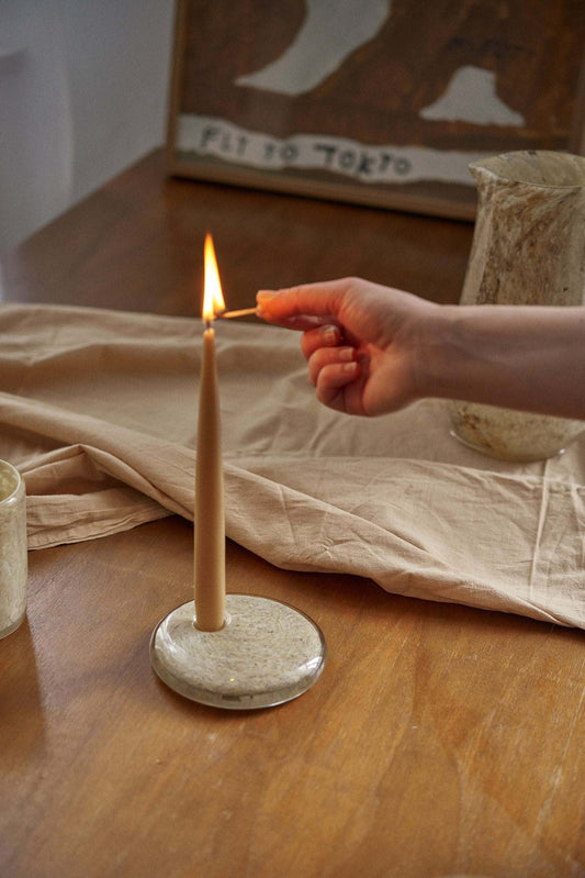 Hand blown glass candle holder with marble-inspired design and rounded shape