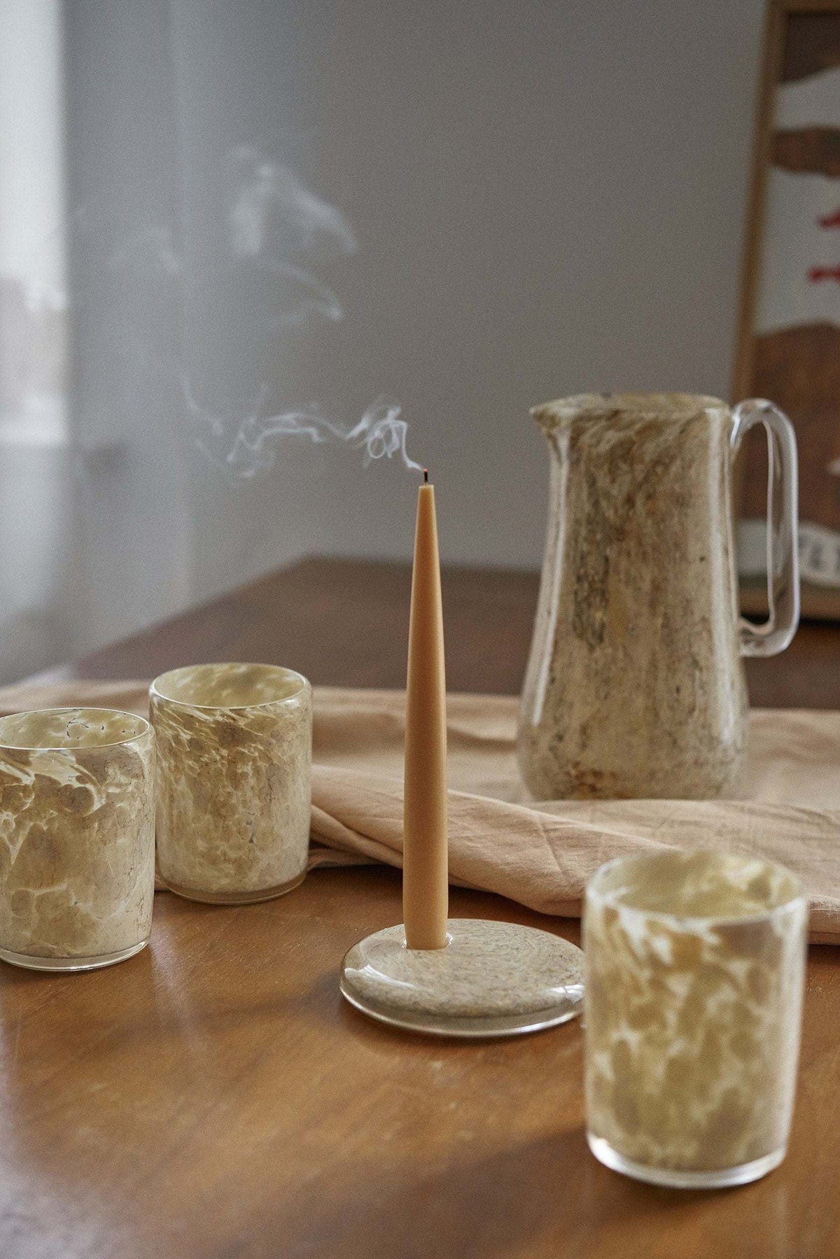 Set of handmade narrow taper candles in glass holders, showcasing four colors, made from soy wax with cotton wicks for long burn time