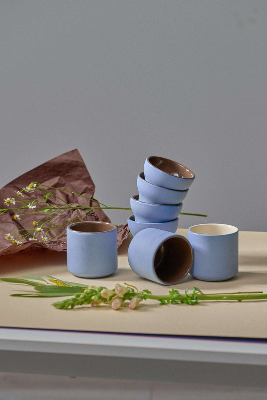Handmade porcelain coffee cup with forget-me-not exterior and chocolate interior glaze