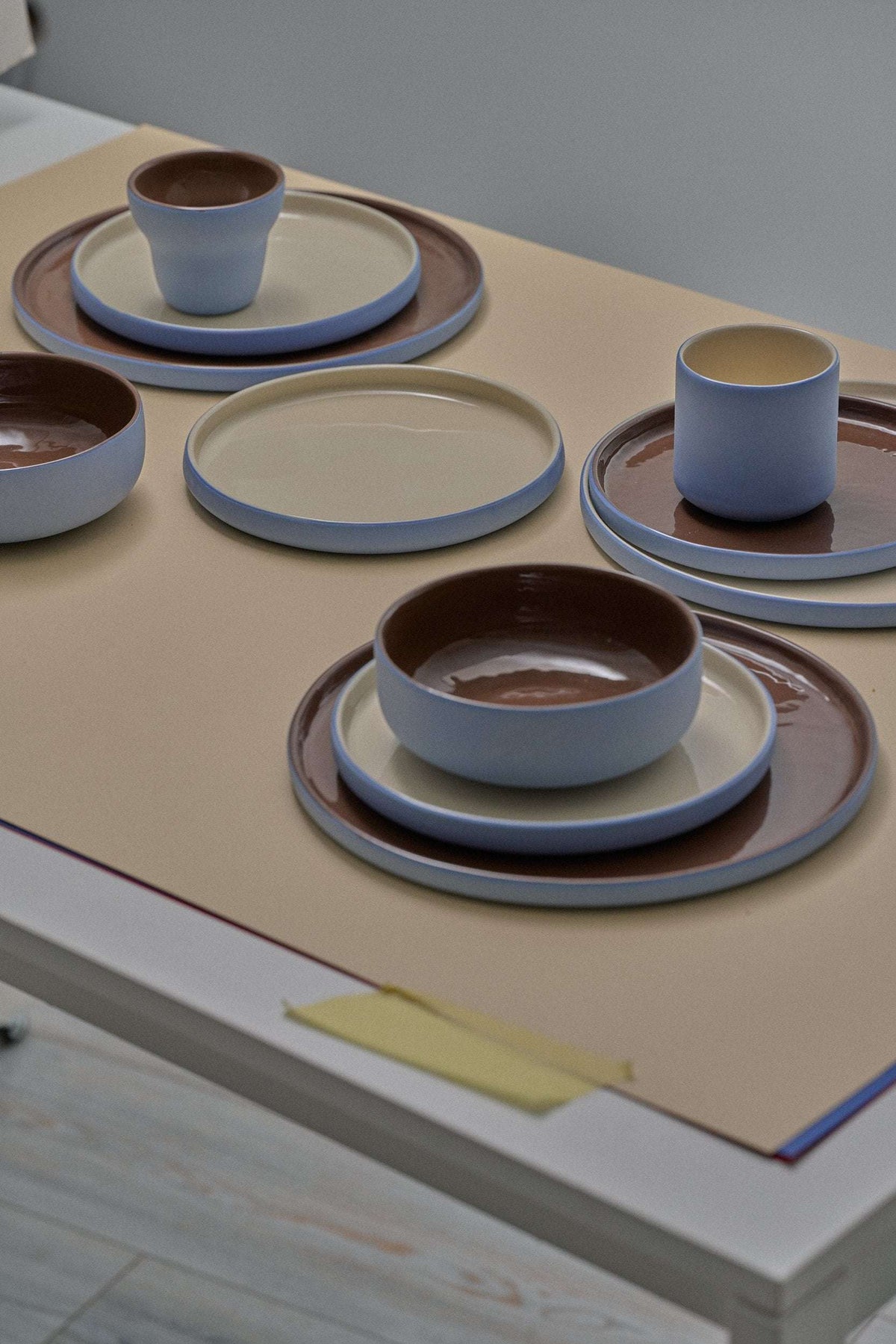 Handmade Blue Porcelain dinner plates and cups in blue with cream interiors and chocolate-brown glazed centers, mix-and-match set.