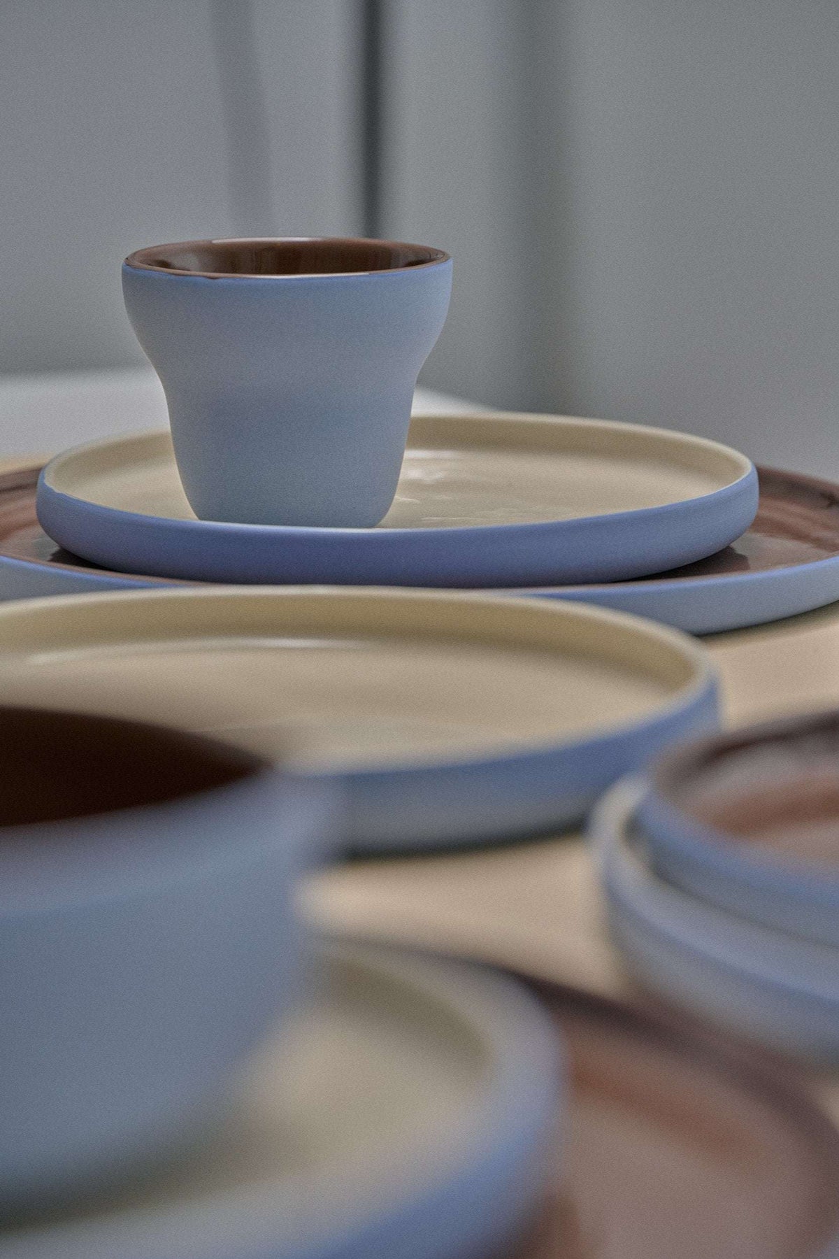 Handmade porcelain pear-shaped coffee cup with forget-me-not exterior and chocolate interior glaze