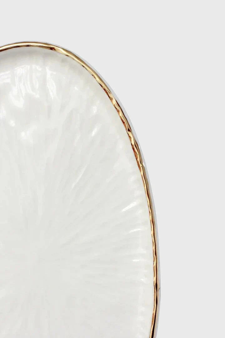 Handmade Porcelain oval serving platter in off-white with a sculpted radial relief texture and hand-painted gold rim.