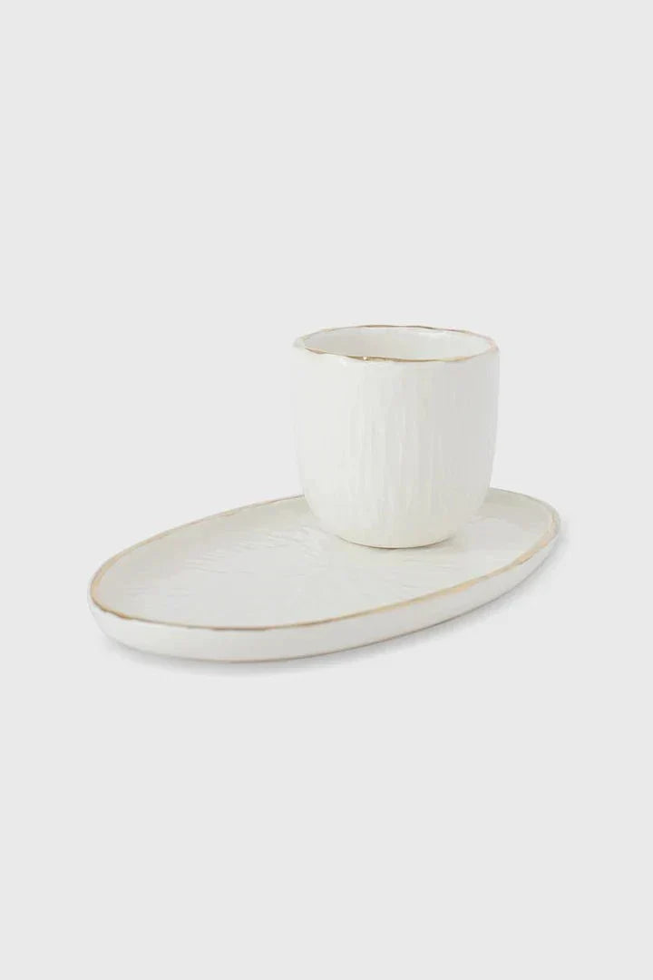 Handmade Porcelain oval serving platter in off-white with a subtle carved relief texture and delicate gold rim, shown with a matching cup.