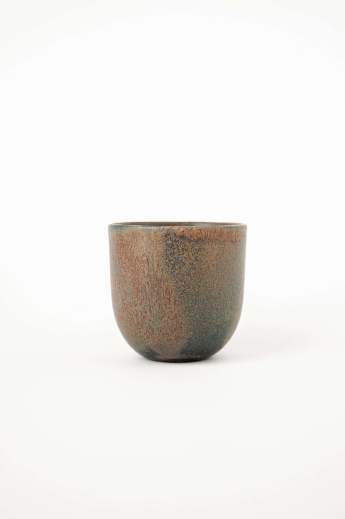 Rust stoneware espresso coffee cup with organic edges and reactive glaze swirl, handmade in Ukraine