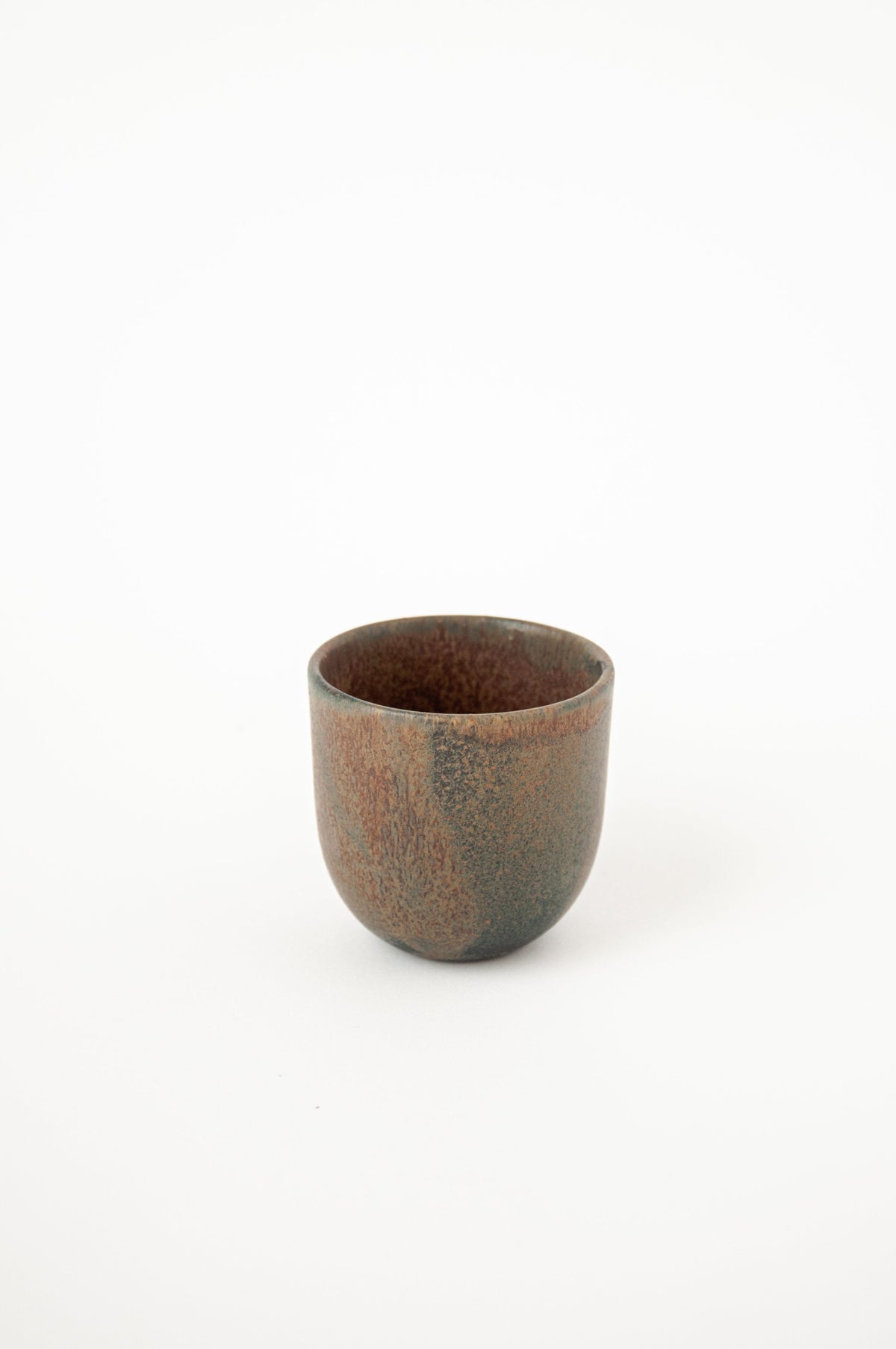 Rust stoneware espresso coffee cup with organic edges and reactive glaze, handmade in Ukraine