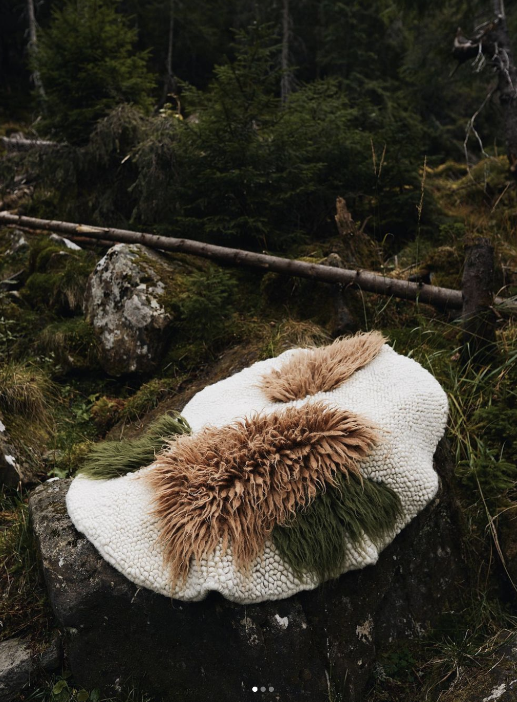 Round handwoven wool area rug in natural forest colors with traditional smooth hand weaving technique