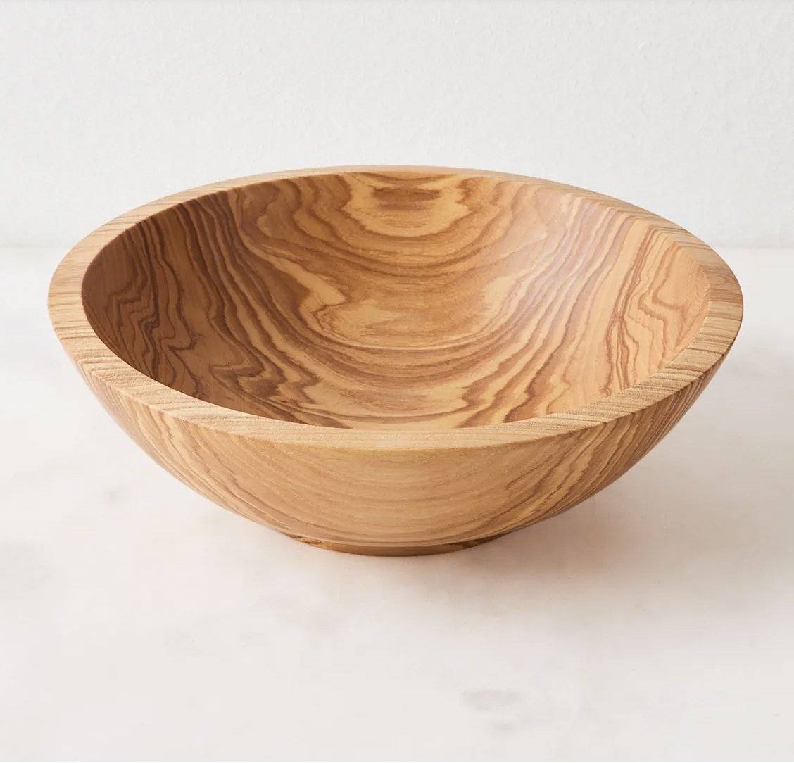 Wooden nesting bowl set in warm honey-brown wood, with a wide rounded shape and striking natural swirling grain.
