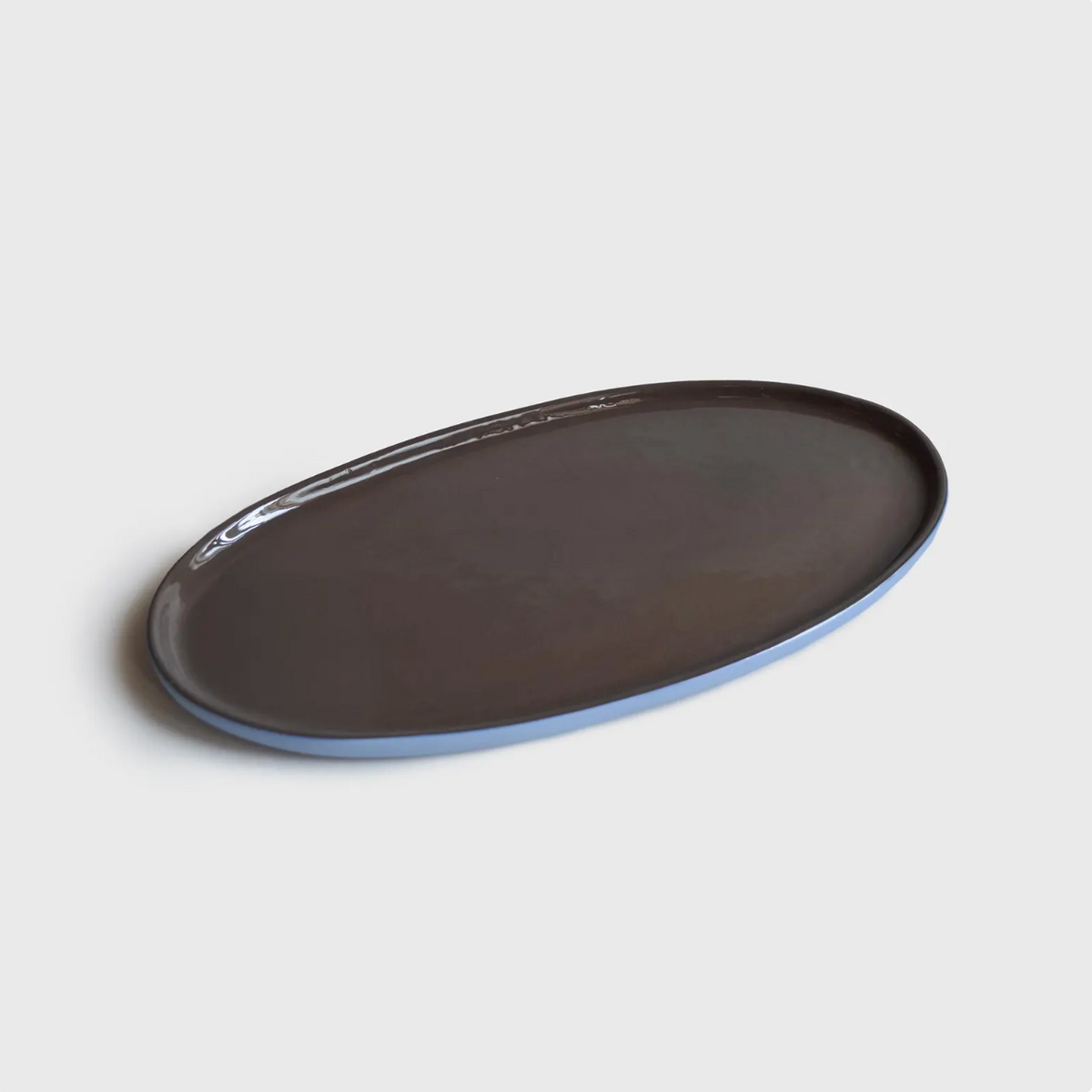Porcelain Serving Platter in an elongated oval shape, featuring a glossy chocolate-brown interior and pale blue rim.