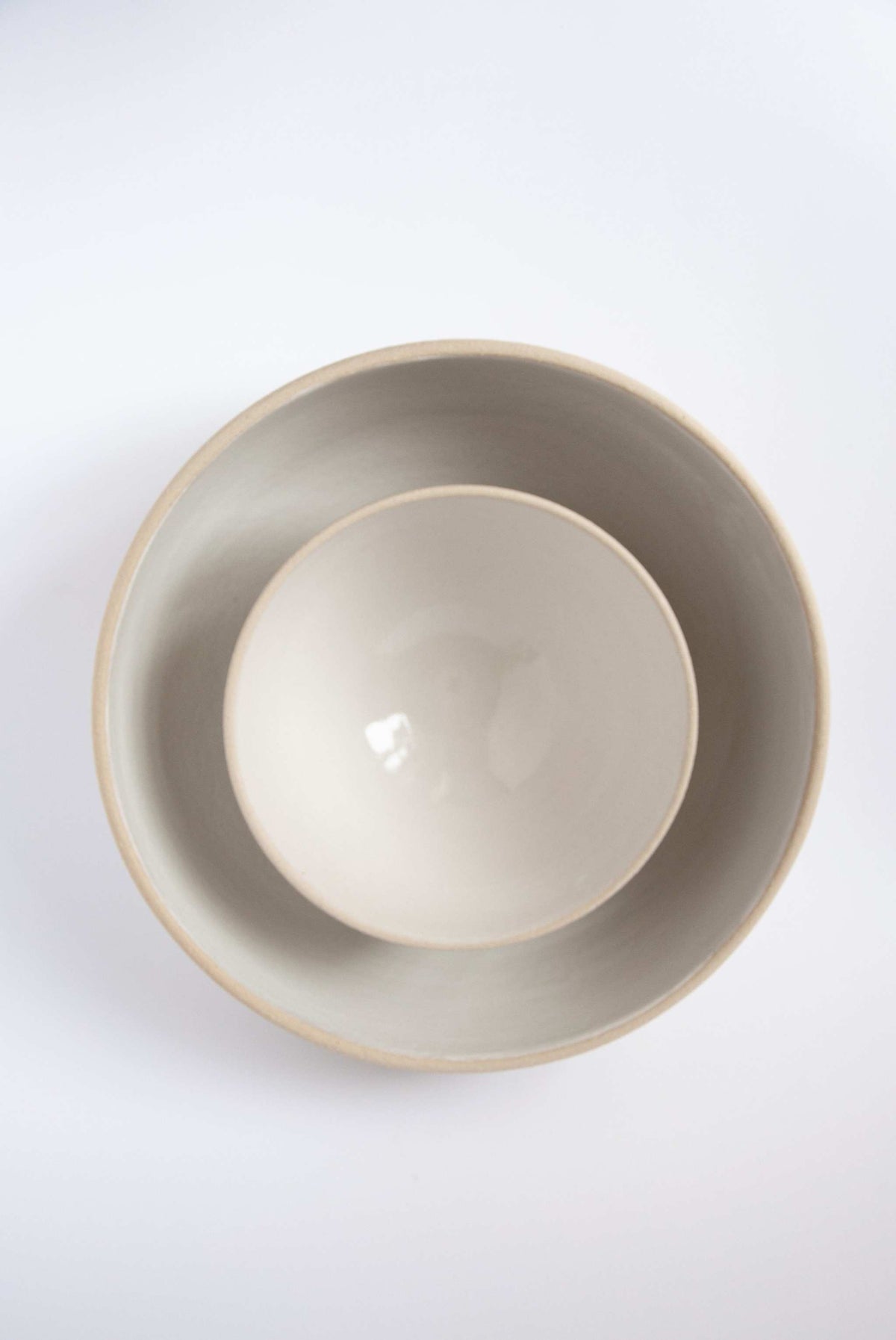 Handmade stoneware large fruit bowl with white glazed interior, rustic texture, and natural pores, perfect for fruits and salads