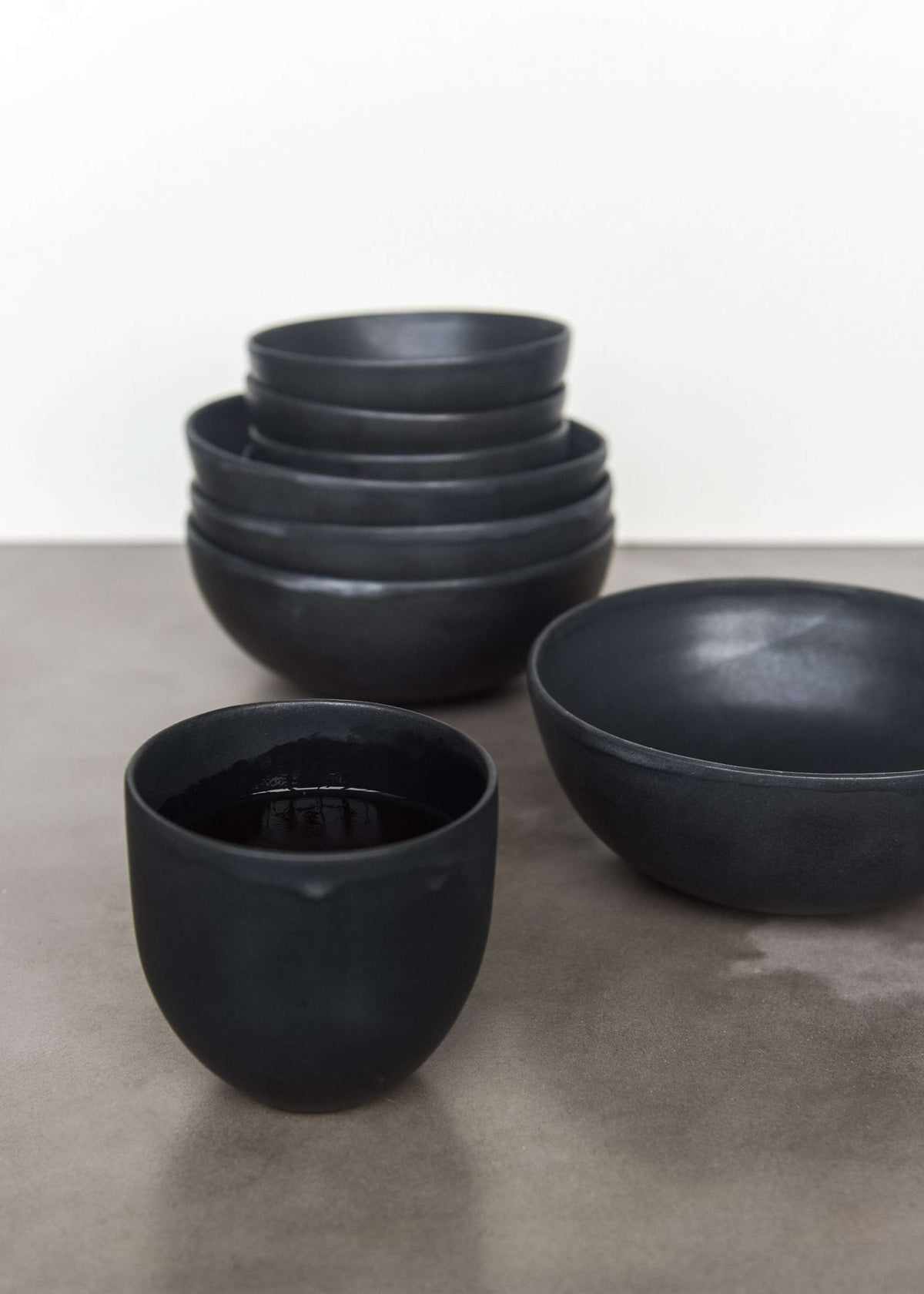Handmade black matte stoneware bowl with organic curves and food-safe glaze