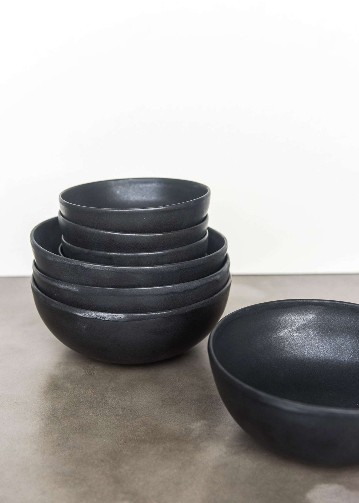 Handmade black matte stoneware bowl with lighter rim and artisanal glaze, food-safe and dishwasher safe