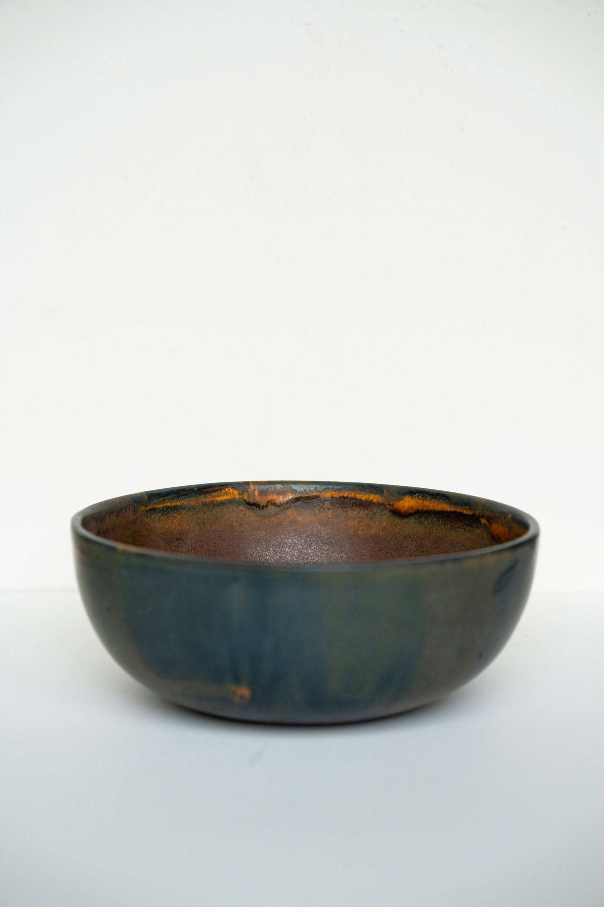 Rust stoneware nesting bowl set with matte brown-black reactive glaze and unique swirls, handcrafted in Ukraine