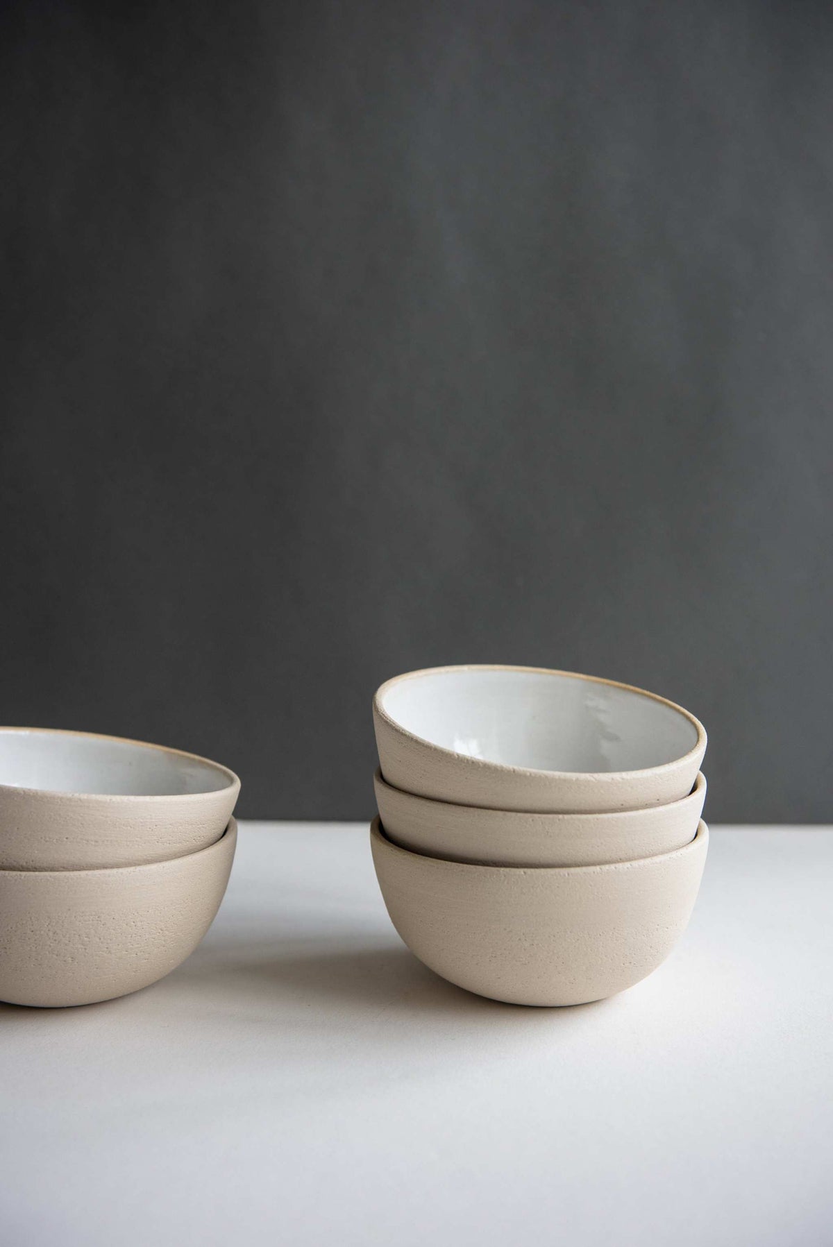 Handmade stoneware small bowl with textured exterior and smooth white glazed interior
