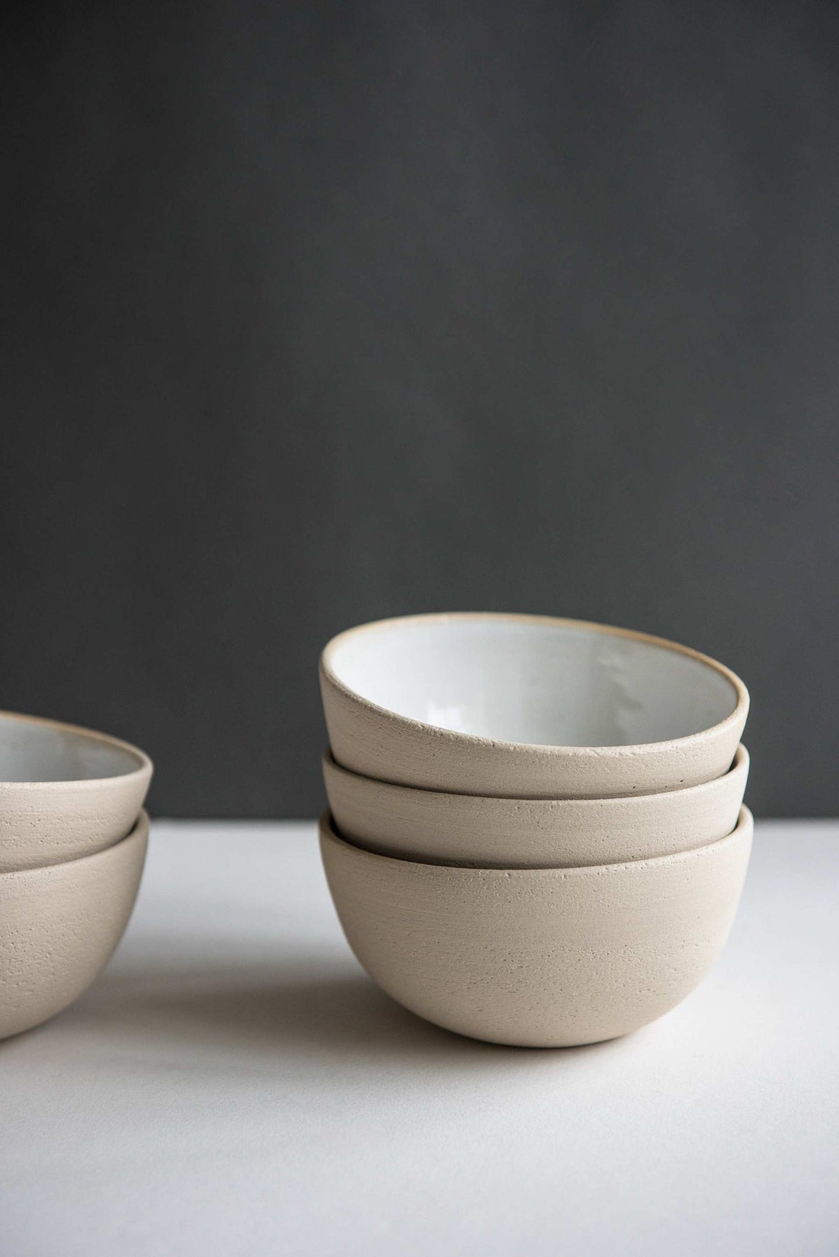 Handmade stoneware small bowl with textured exterior and smooth white glazed interior