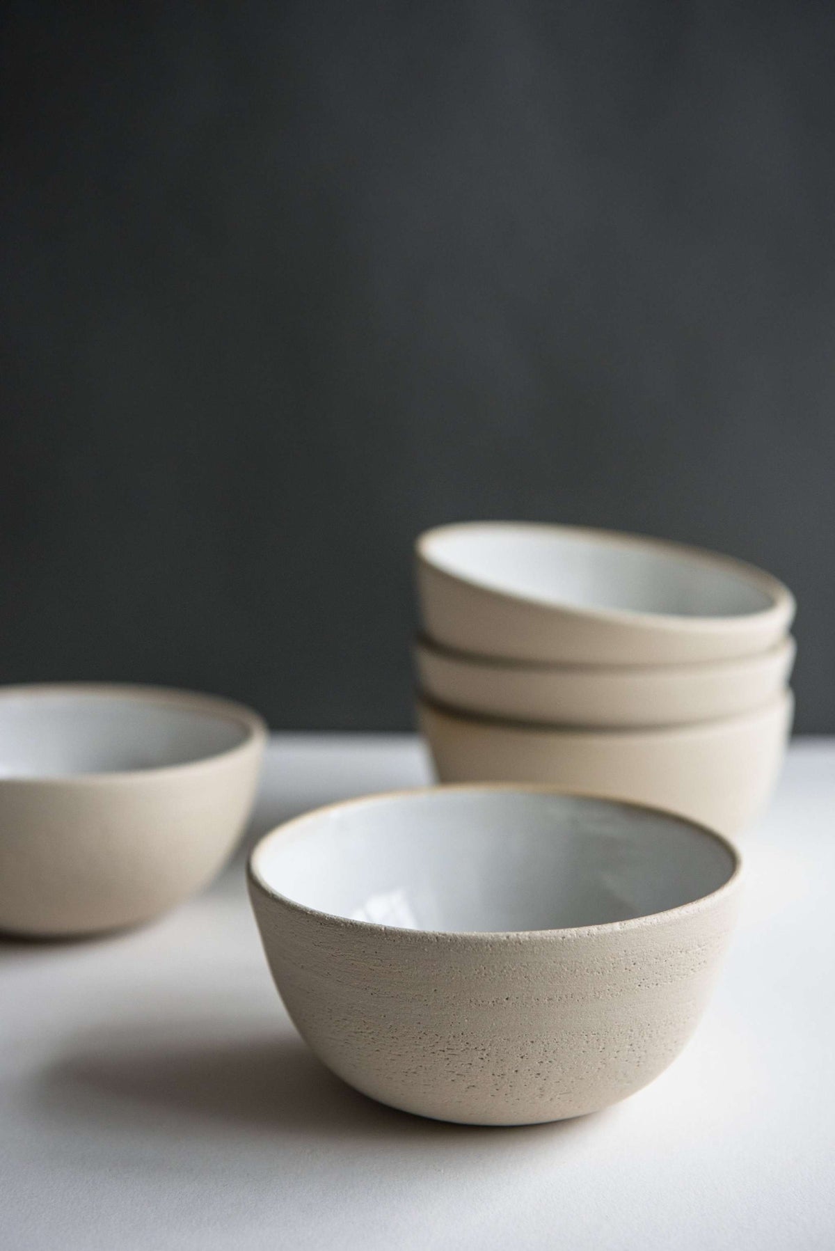 Handmade stoneware small bowl with textured exterior and smooth white glazed interior