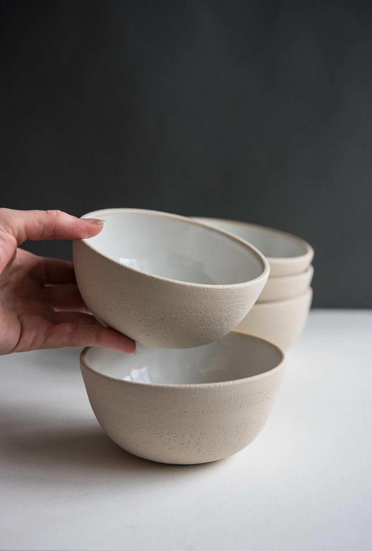 Handmade stoneware small bowl with textured exterior and smooth white glazed interior, dishwasher and microwave safe, crafted in Ukraine
