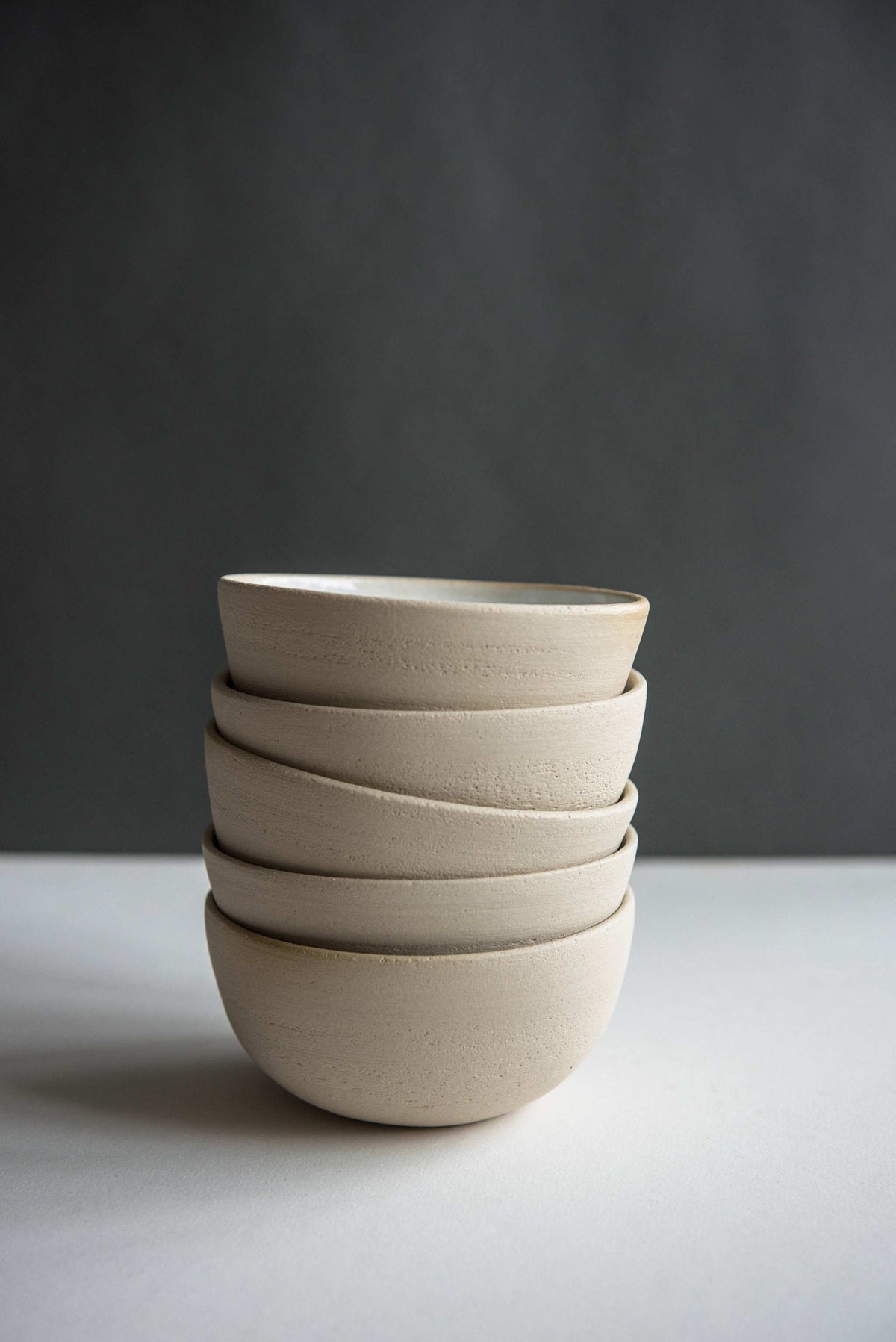 Handmade stoneware small bowl with textured exterior and smooth white glazed interior