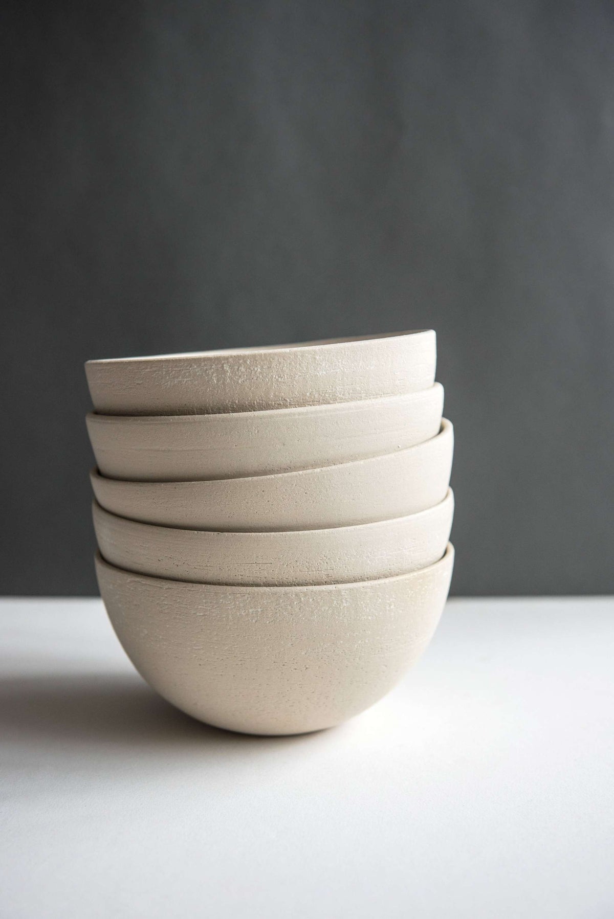 Handmade stoneware soup bowl with white glaze, rustic texture, and smooth sides, perfect for soups and salads.
