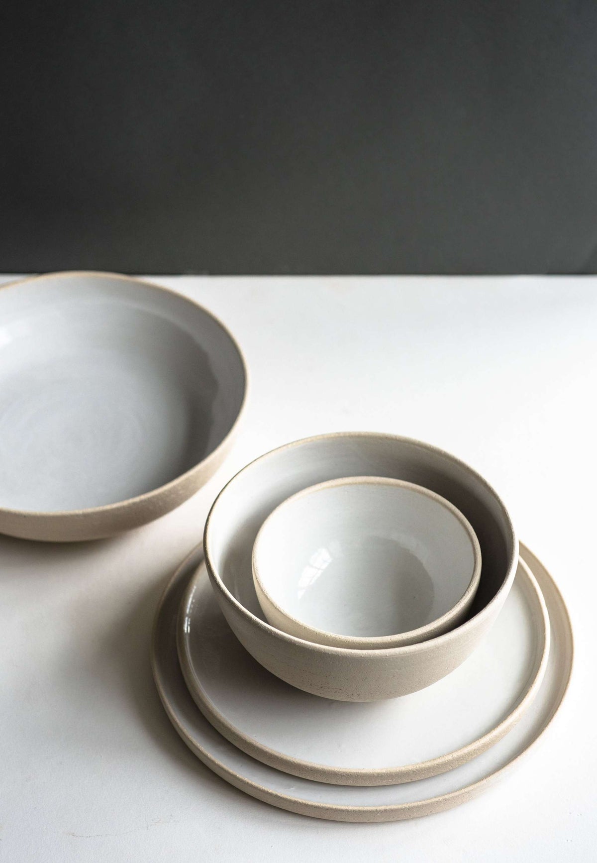 Stoneware Pasta Bowl in matte cream stoneware with a smooth white-glazed interior and simple rounded rim.