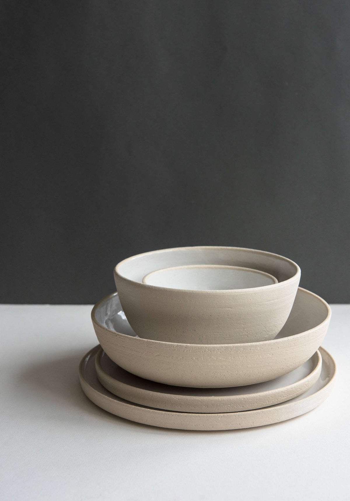 Handmade stoneware soup bowl with white glazed interior and rough exterior pores, made in Ukraine