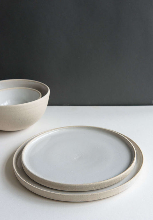 Handmade stoneware plate with white glaze and textured rough edges, made in Ukraine