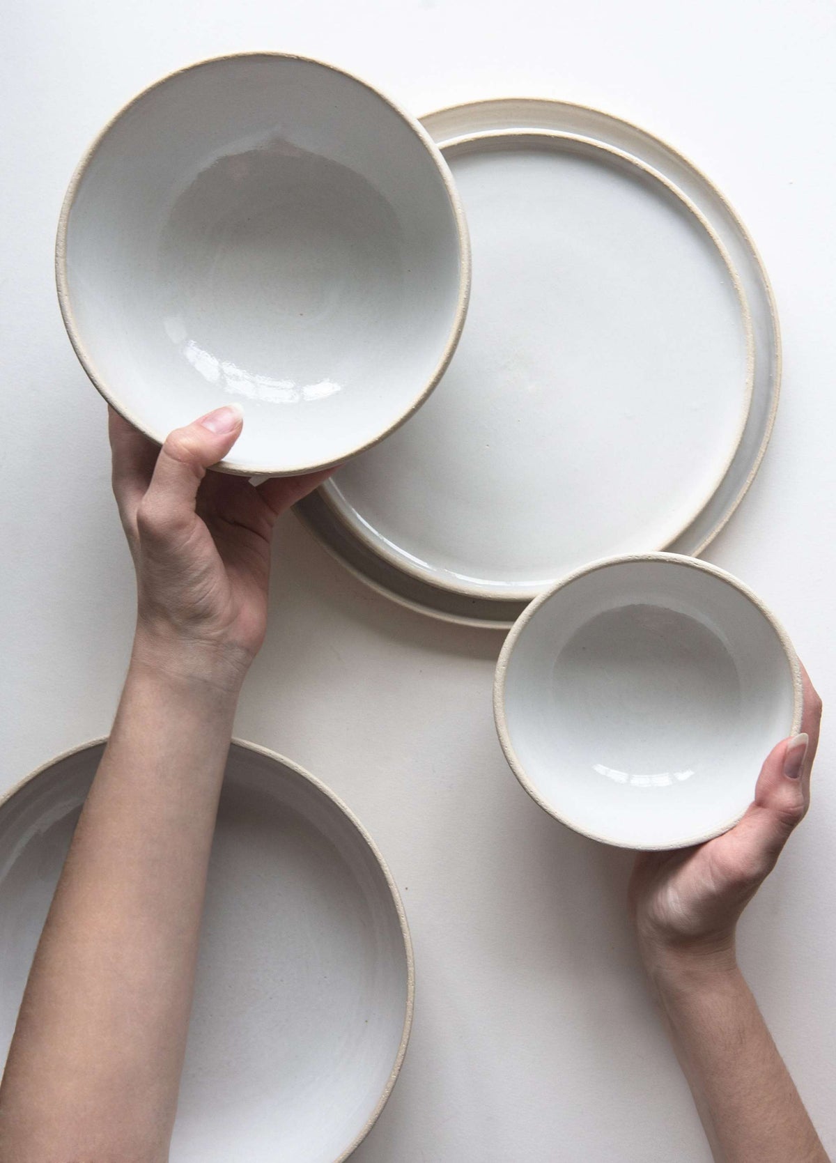 Handmade stoneware soup bowl with white glazed interior and rough textured exterior, dishwasher and microwave safe.