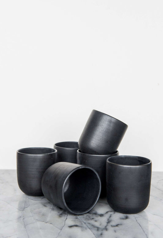 Black matte handmade stoneware cup with organic edges for coffee and tea