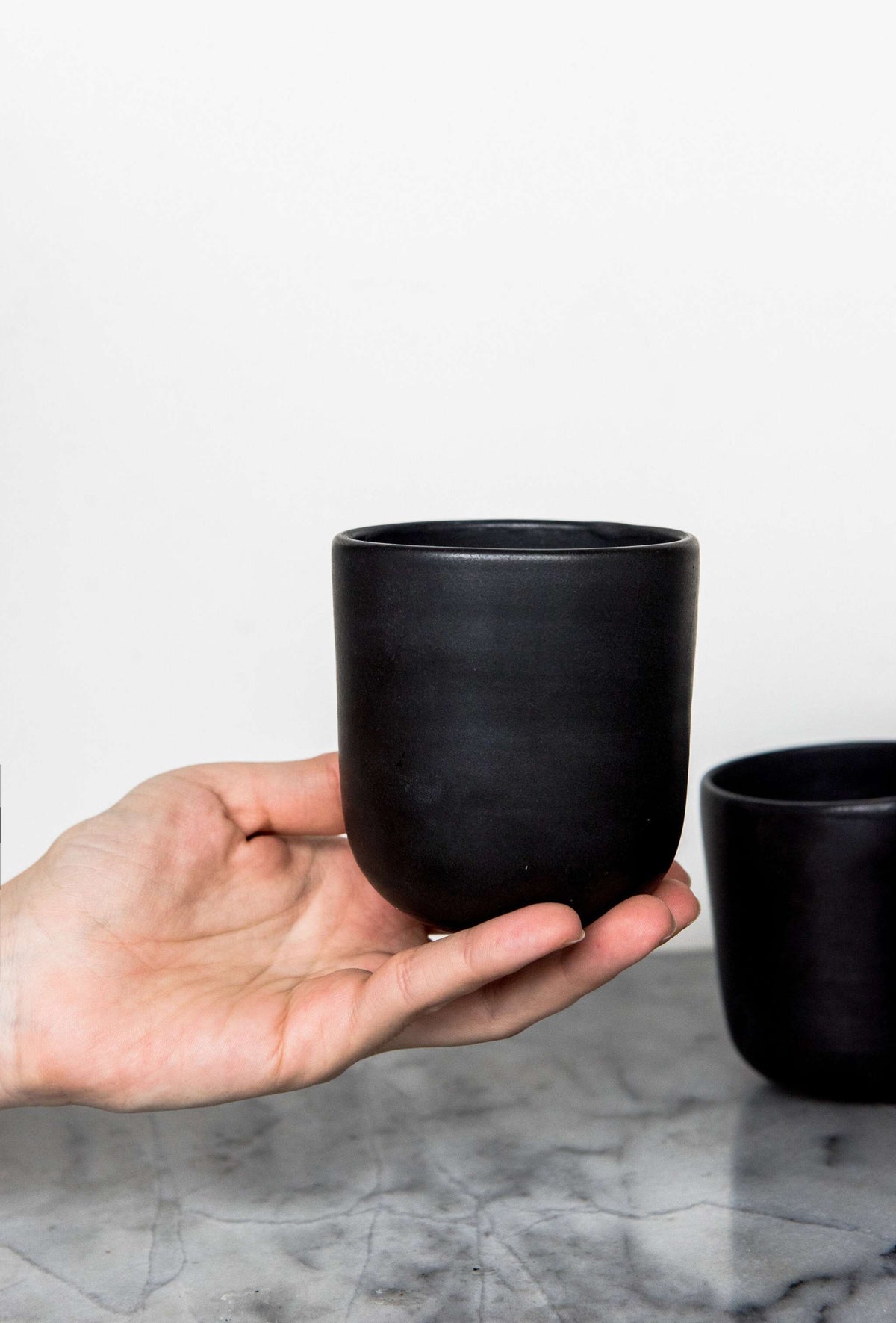 Handmade black matte stoneware cup with organic edges for coffee and tea, microwave and dishwasher safe, made in Ukraine