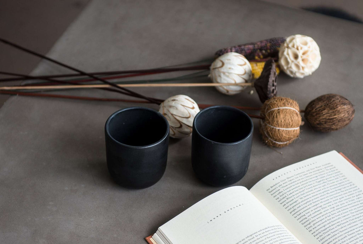 Handmade black matte stoneware cup with organic edges for coffee and tea