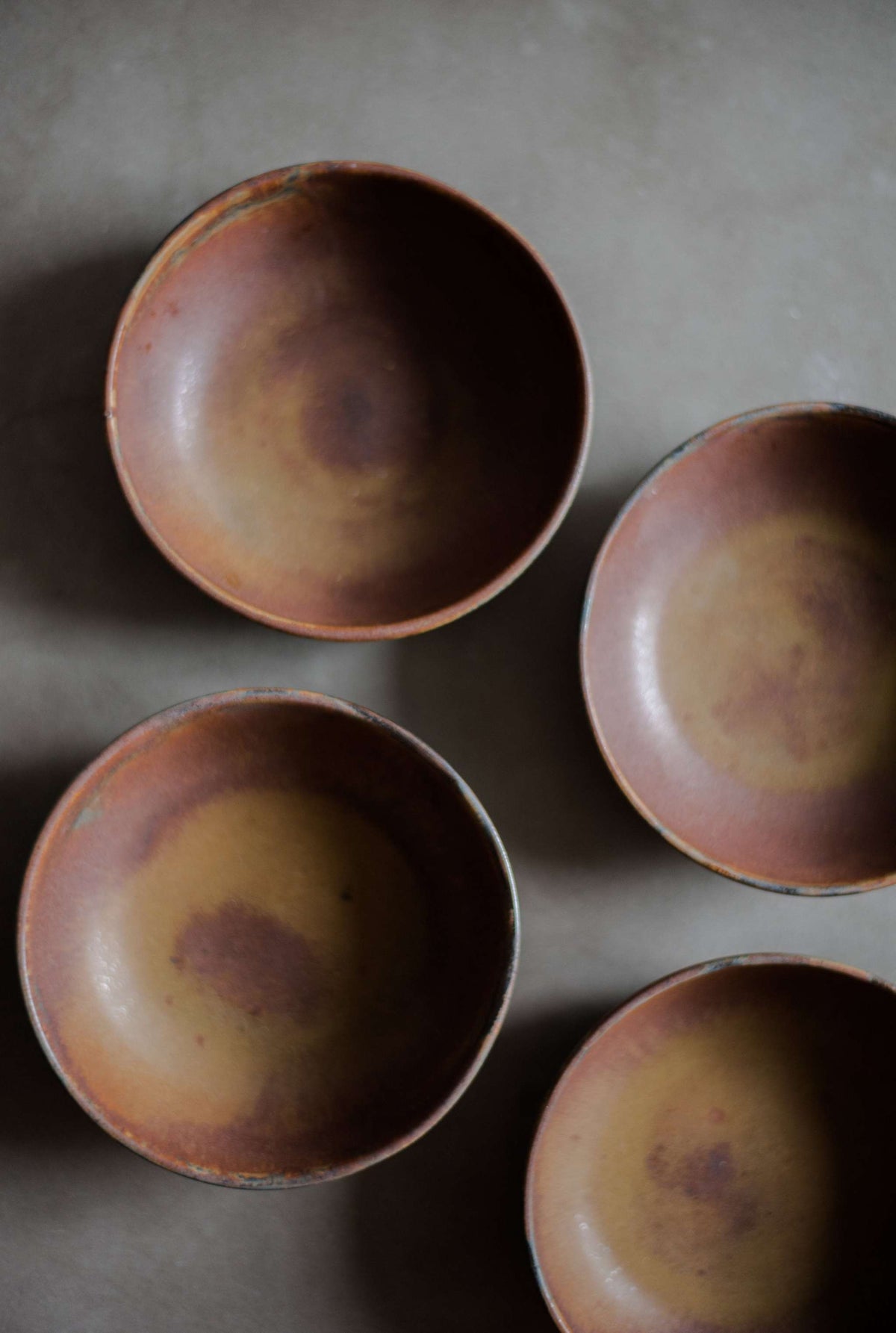 Rust stoneware mini bowl hand-dipped in matte reactive glaze, handmade in Ukraine with unique swirl patterns