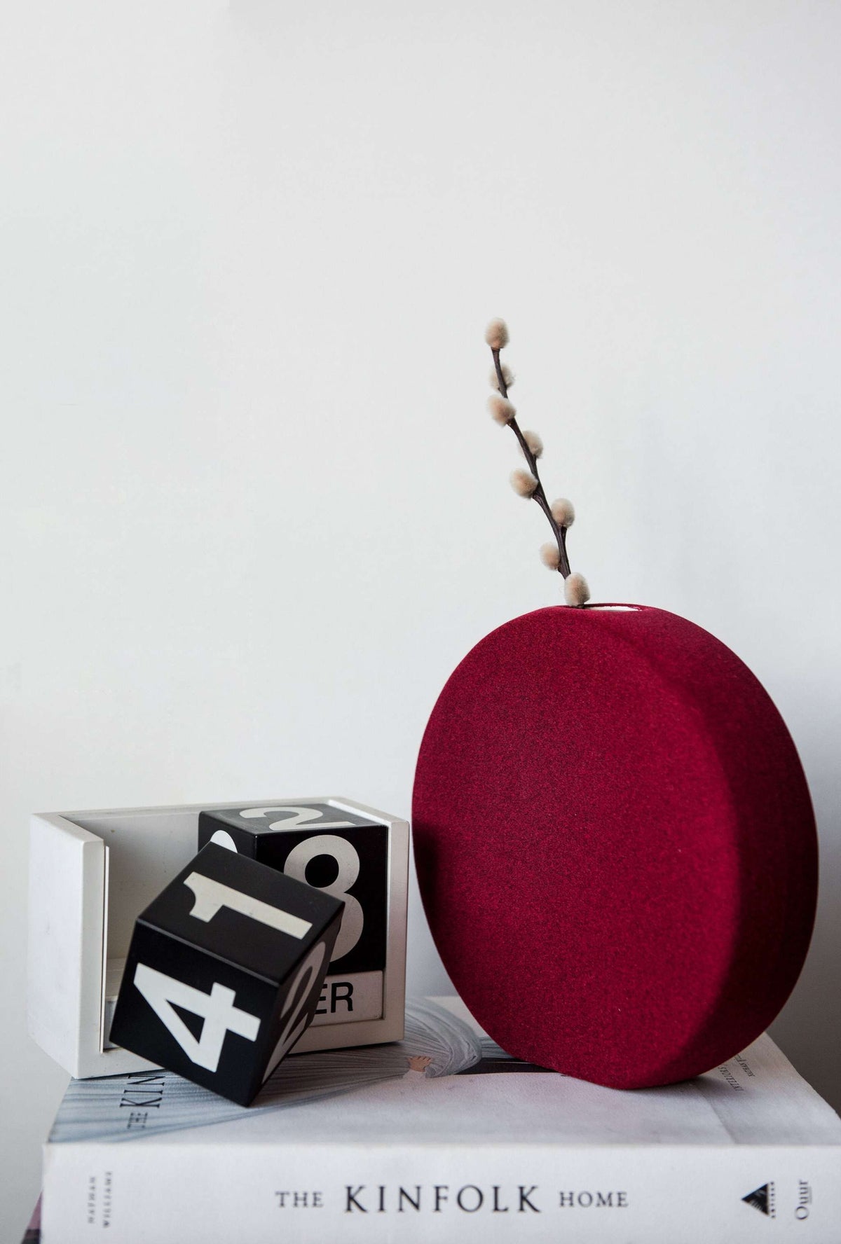 Porcelain set of home decor with burgundy geometric vases including tall tube, round, and sphere shapes