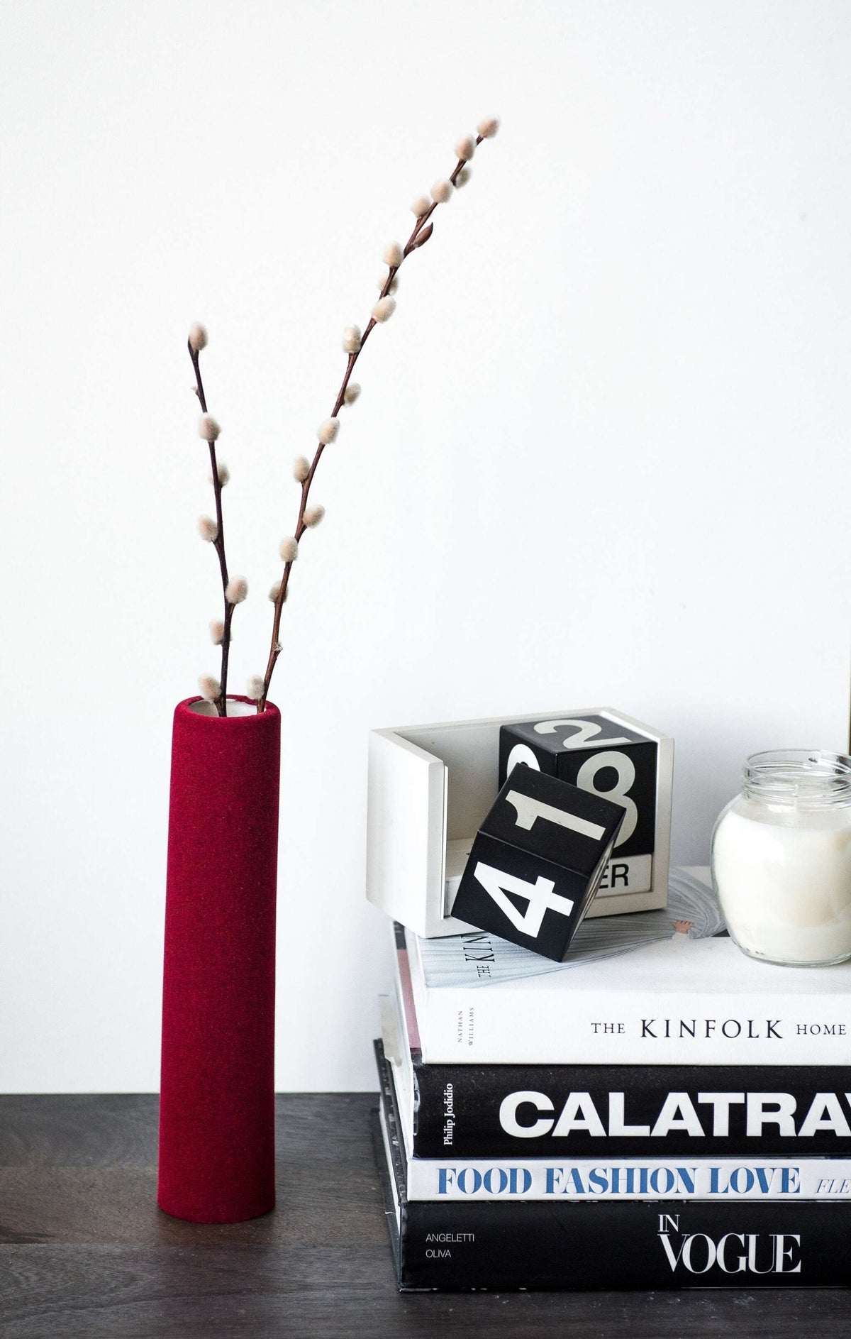Porcelain set of home decor geometric objects including a burgundy tube vase
