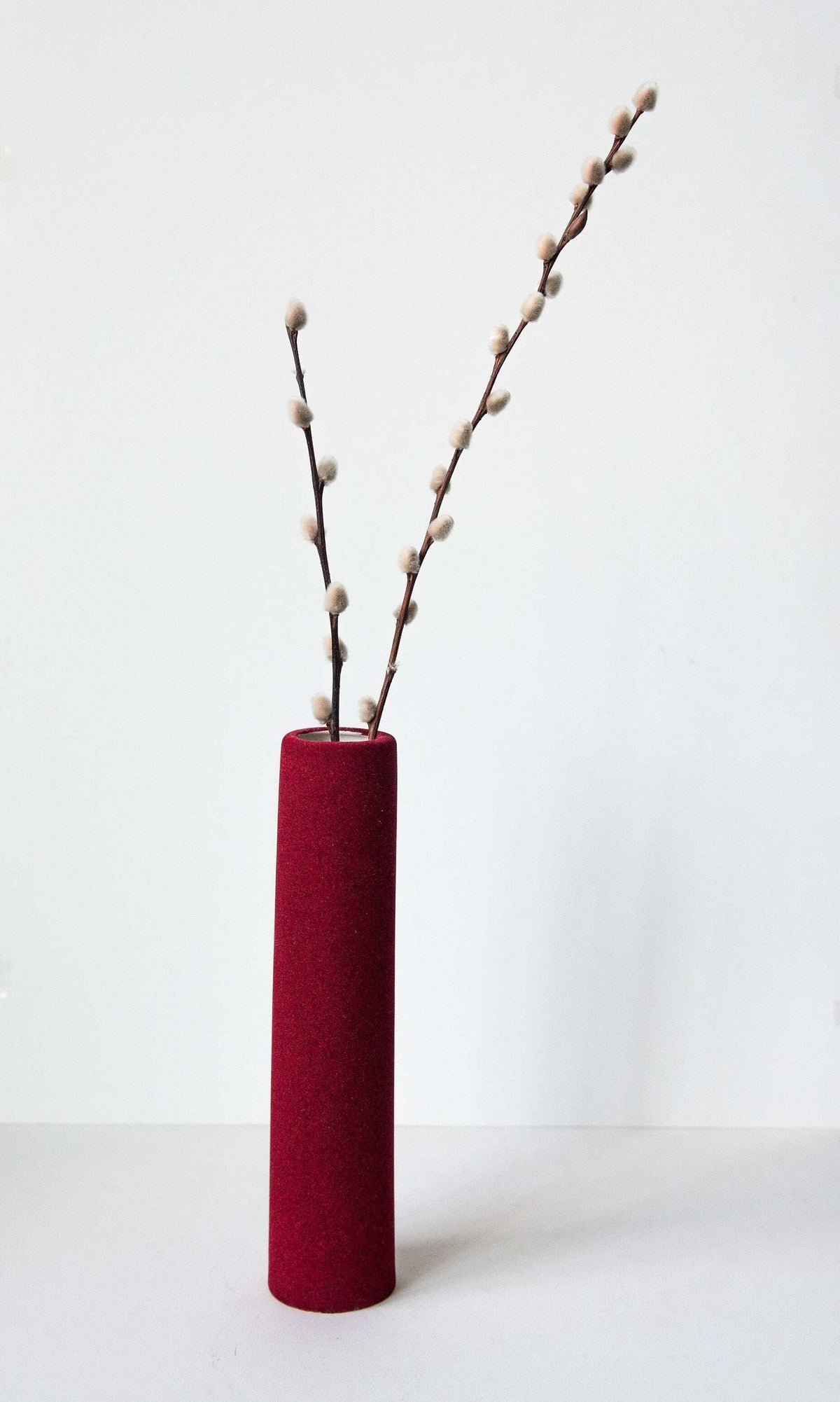 Porcelain set of home decor geometric objects with burgundy tube vase