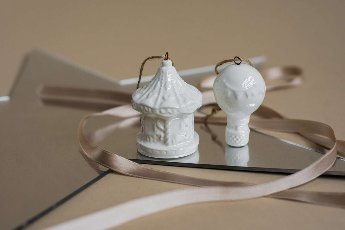 Handmade white porcelain Christmas ornaments with rustic jute loops, made in Ukraine for holiday decor