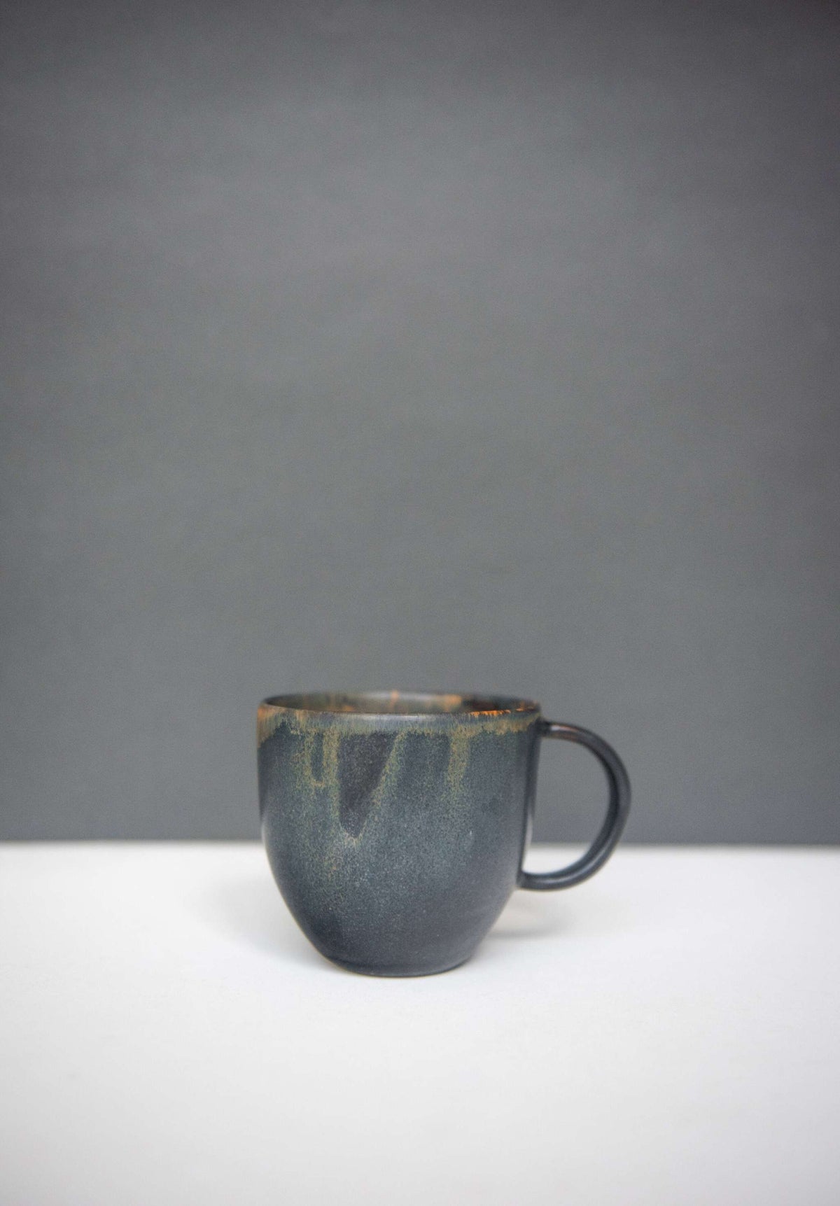 Rust stoneware coffee mug with handle and unique reactive glaze swirl, handmade in Ukraine