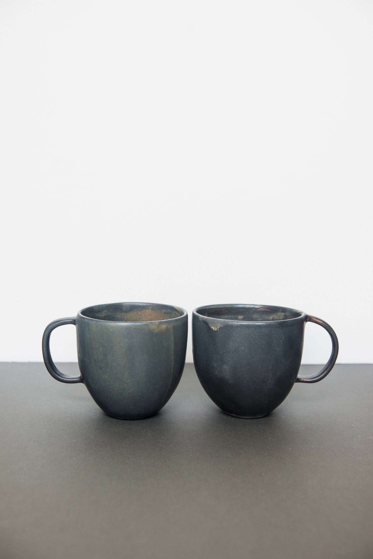 Rust stoneware coffee mug with organic edges and reactive glaze, handmade in Ukraine, dishwasher safe