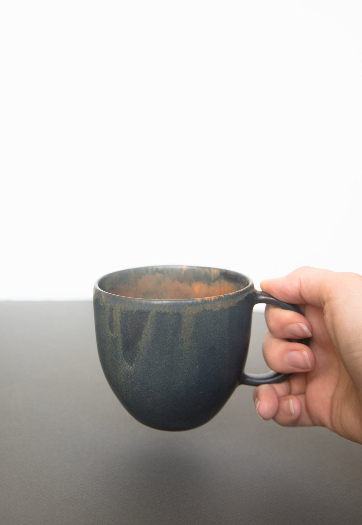 Rust stoneware mug with handle and organic edges in reactive glaze, handmade in Ukraine, durable and dishwasher safe
