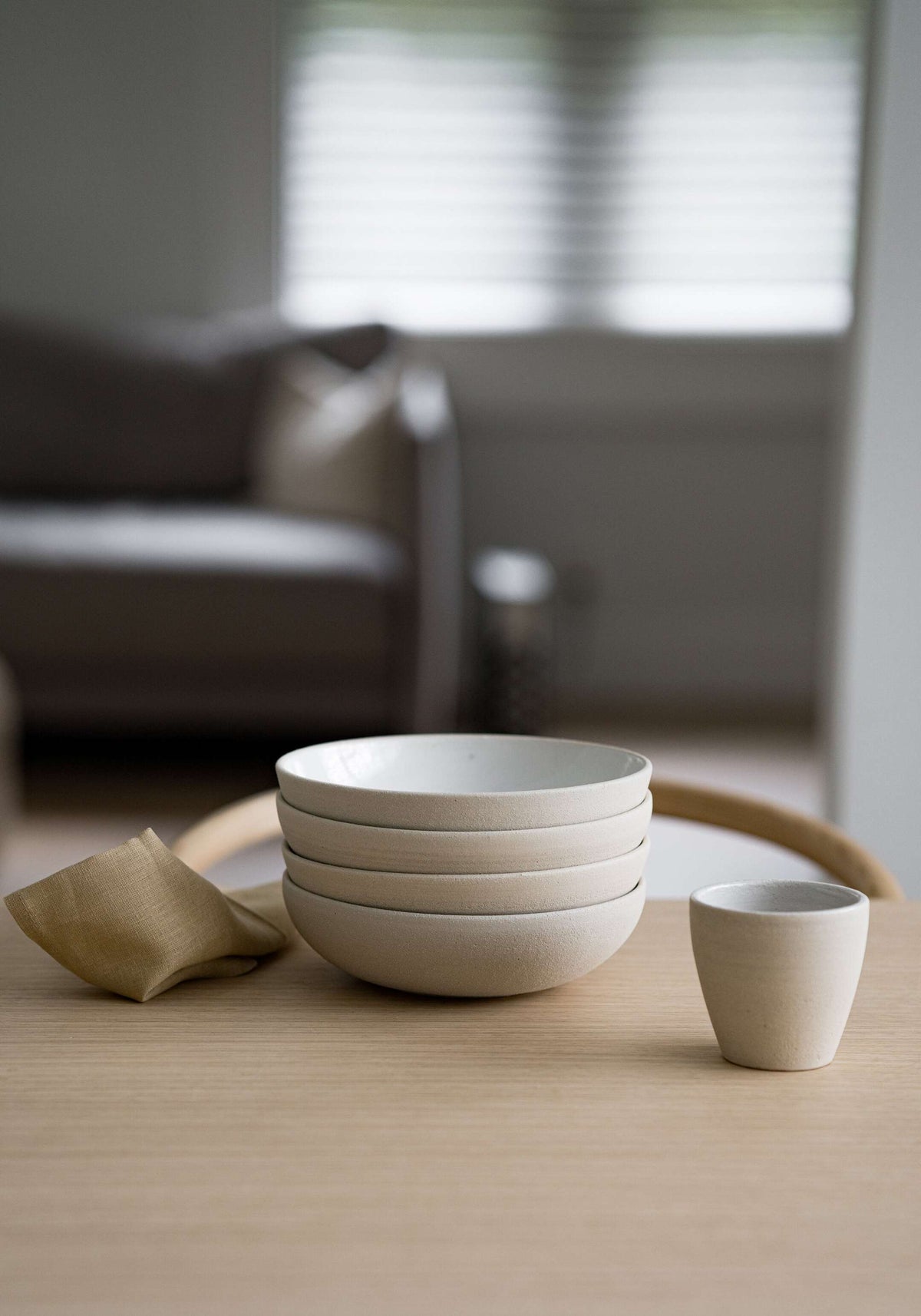 Handmade stoneware coffee cup with rough exterior and white glazed interior, crafted in Ukraine