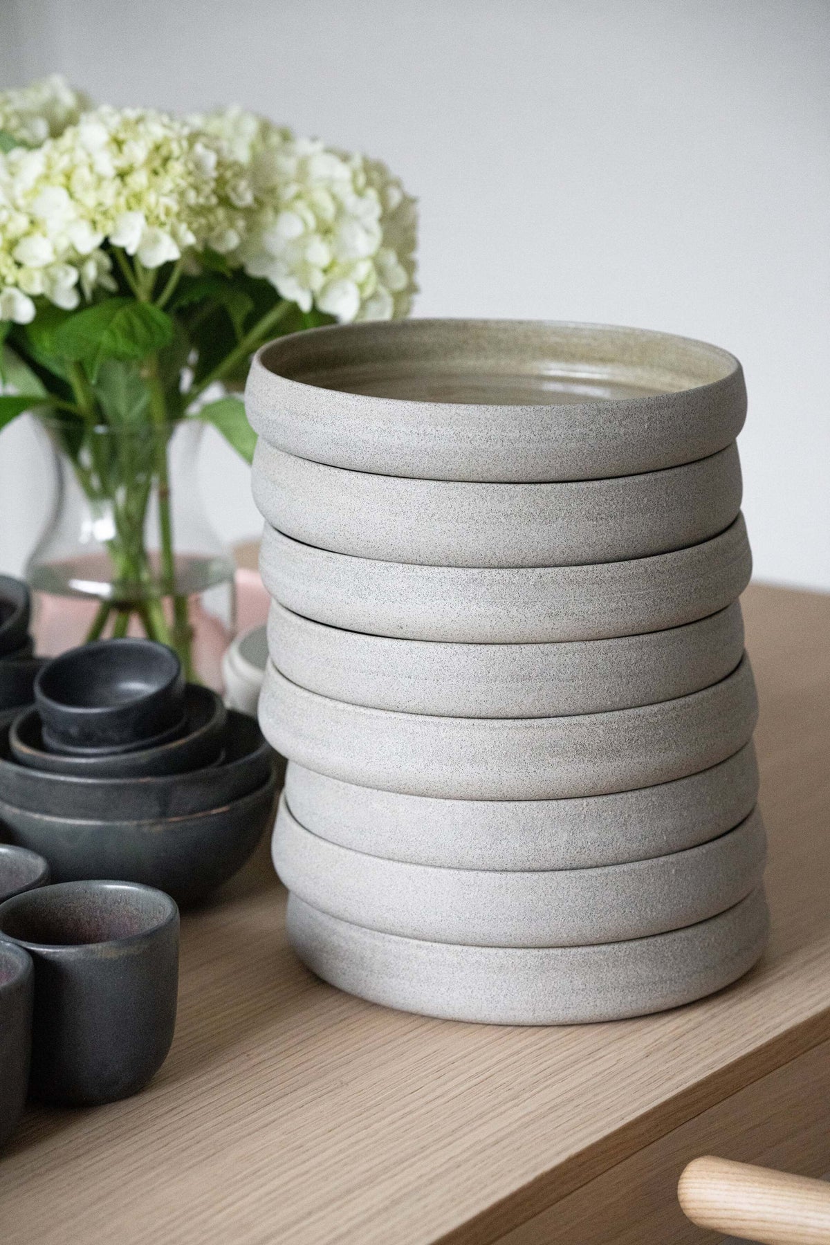 Handmade stoneware dinner plate with high sides in concrete style, glossy glazed inside and rough textured outside