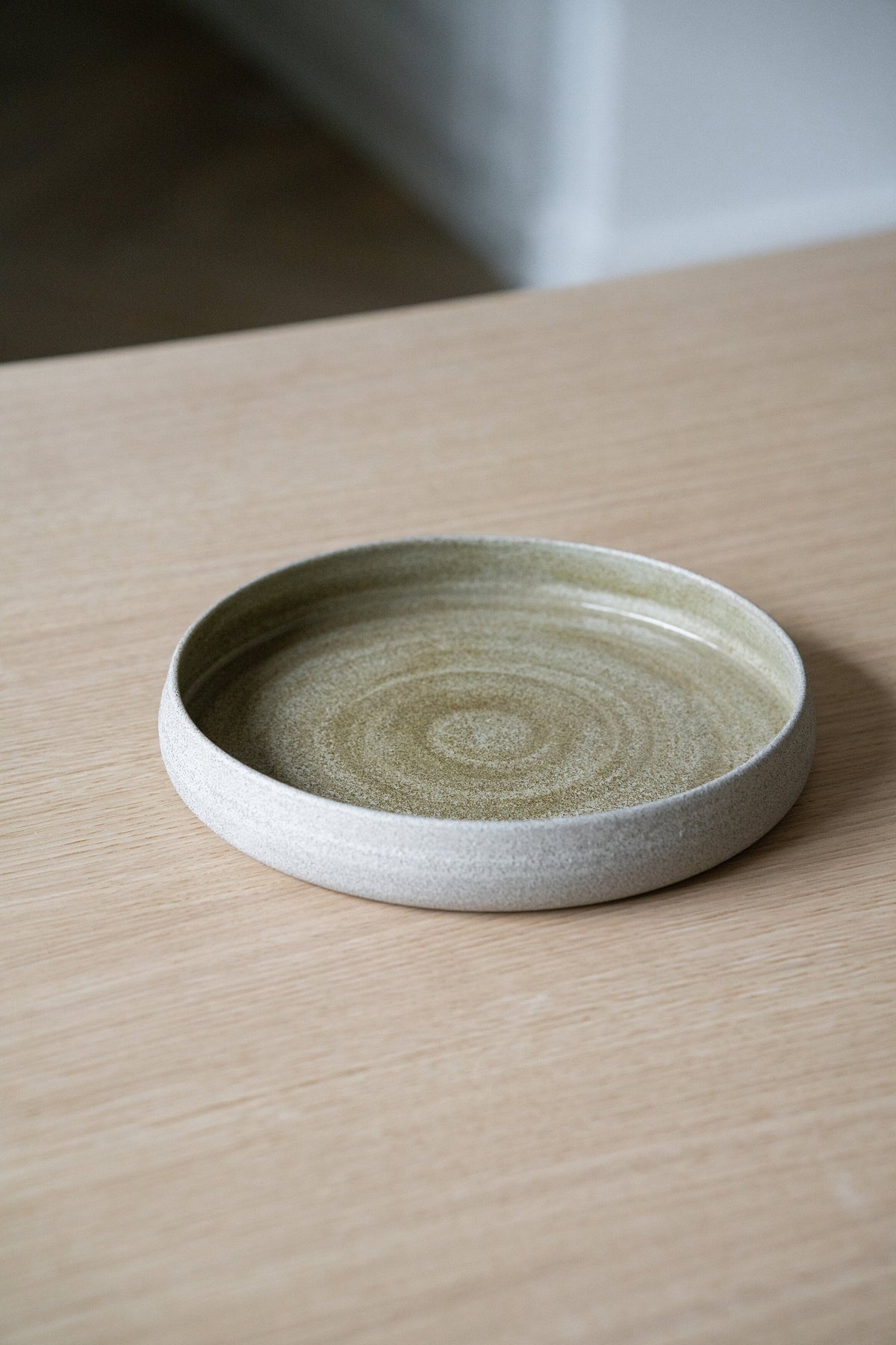 Handmade stoneware dinner plate with high sides in rustic concrete style