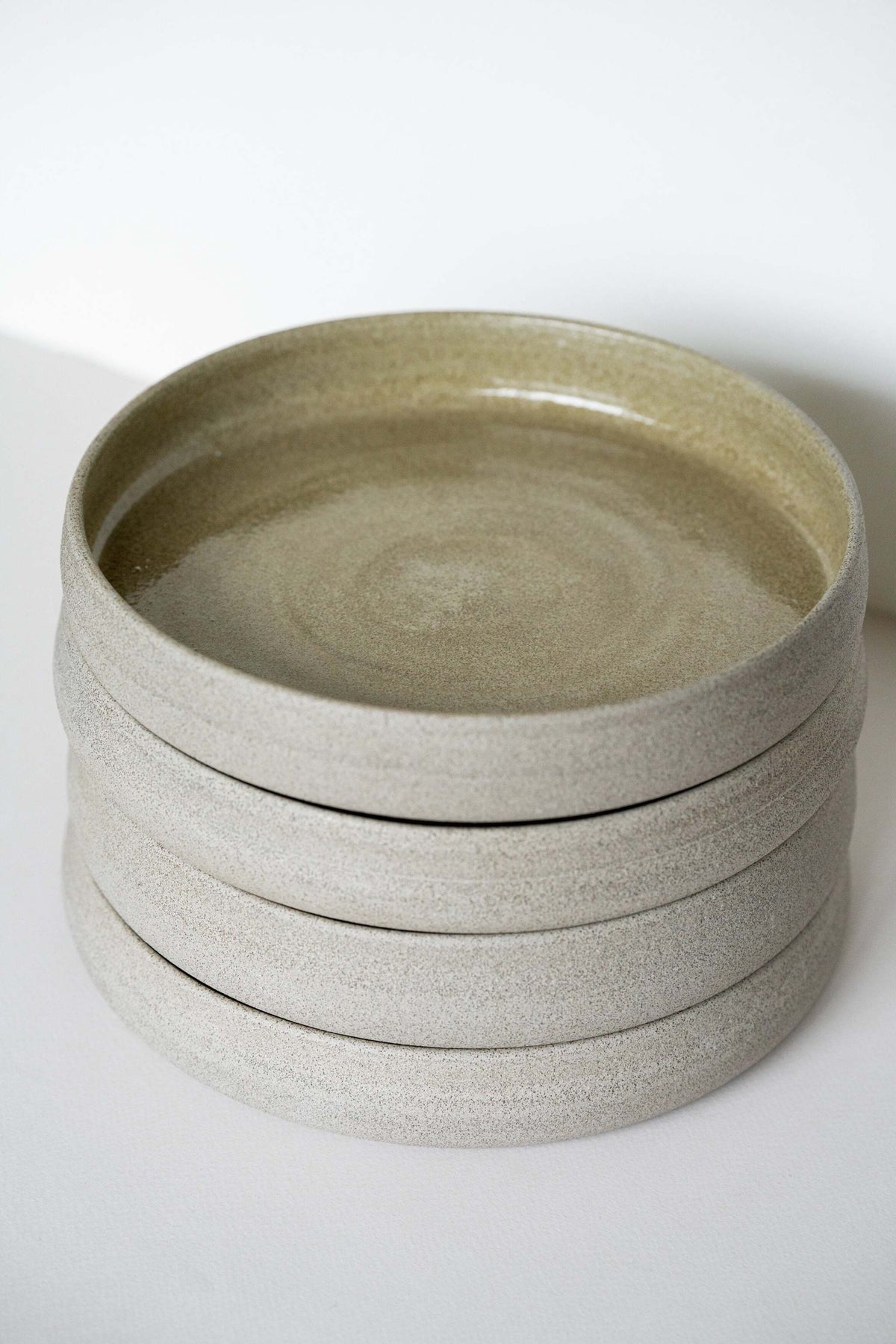Handmade stoneware dinner plate with high sides in rustic concrete style