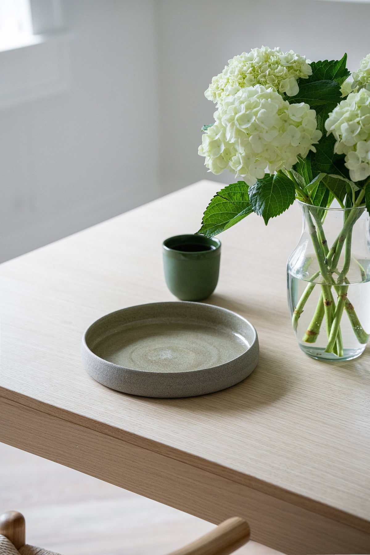 Handmade stoneware dinner plate with high sides in concrete style, rustic exterior and glossy glaze interior