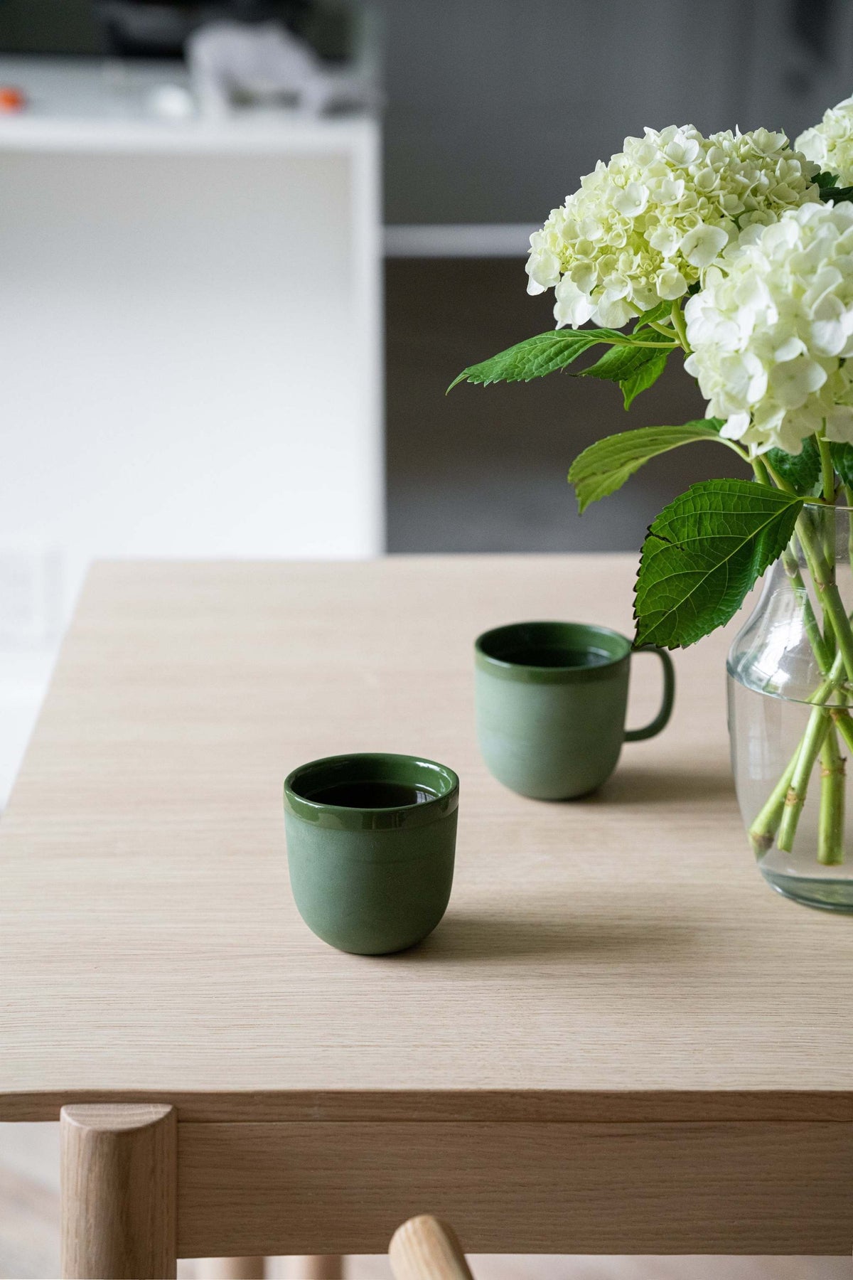 Handmade green porcelain coffee cup with glossy interior and smooth exterior, made in Ukraine