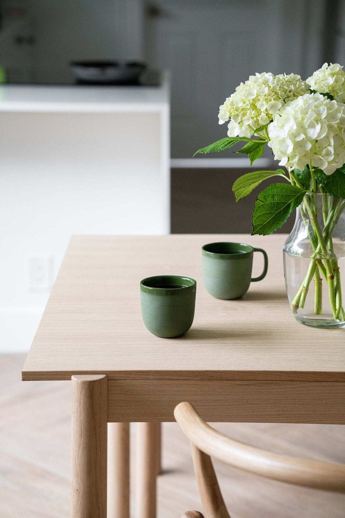 Handmade green porcelain coffee cup with glossy glaze and unique finish