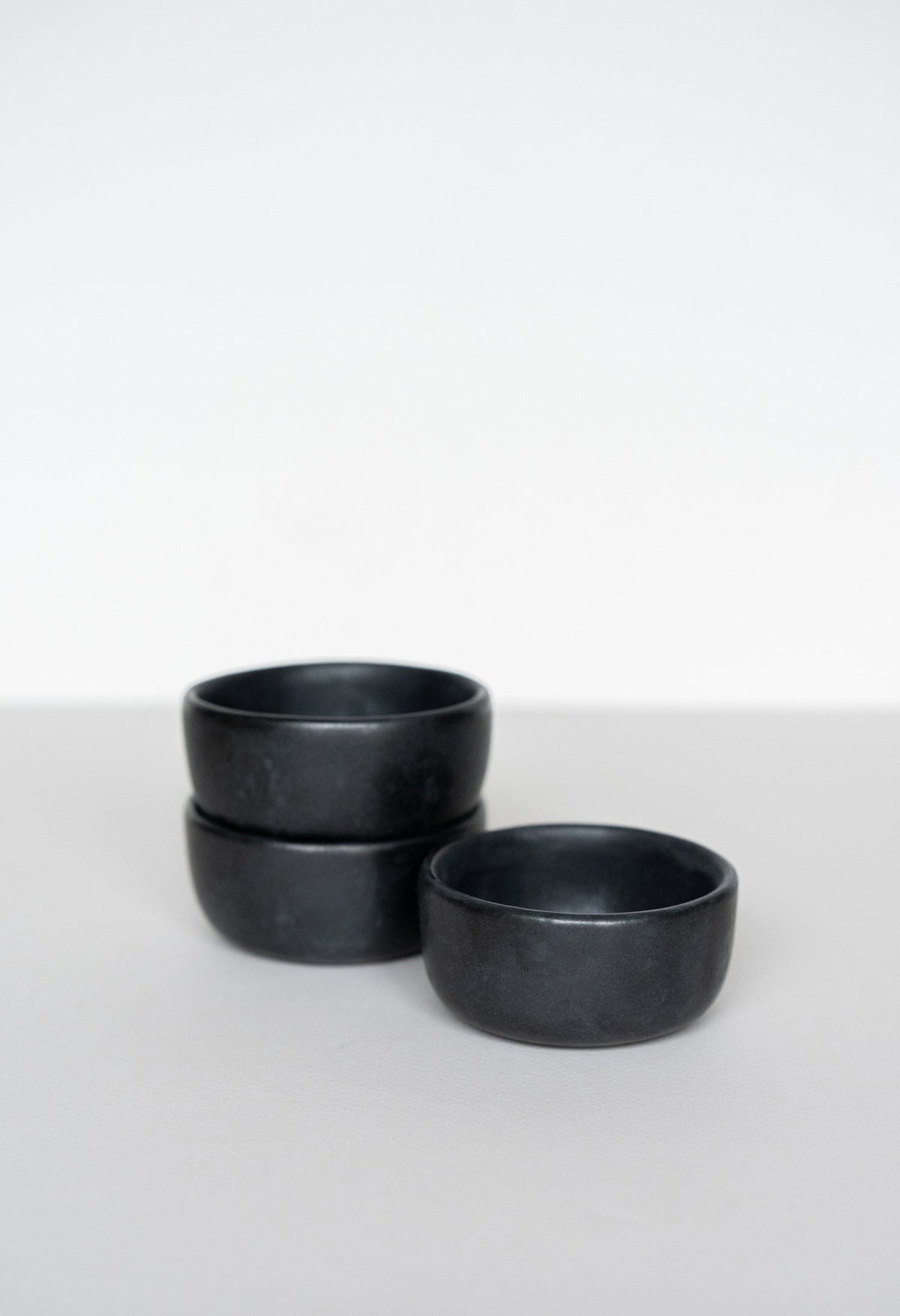 Black matte stoneware pinch bowl handmade in Ukraine with food-safe glaze and dishwasher-safe finish