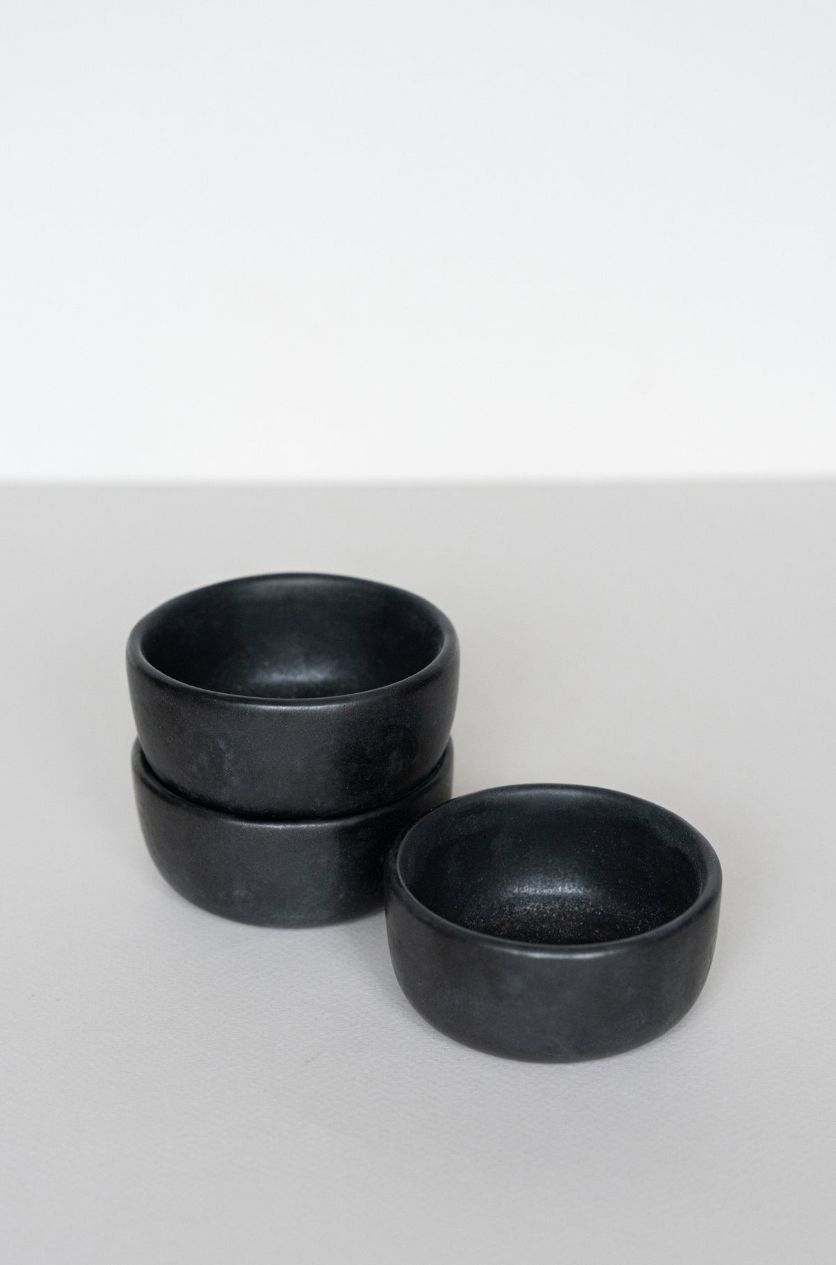 Black matte stoneware pinch bowl handcrafted in Ukraine, dishwasher and microwave safe, unique deep condiment bowl